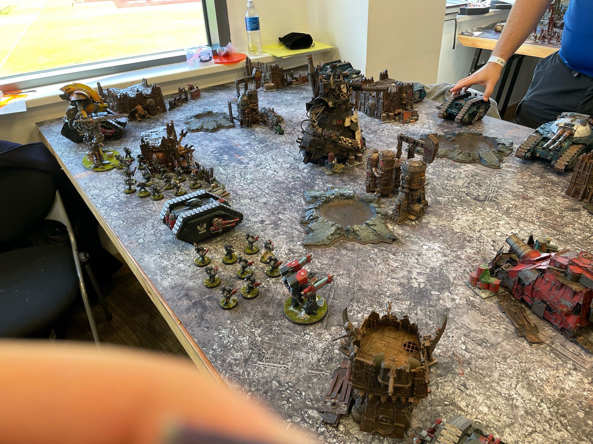 Two Horus Heresy armies lined up for a game. There is a finger in shot (sigh)