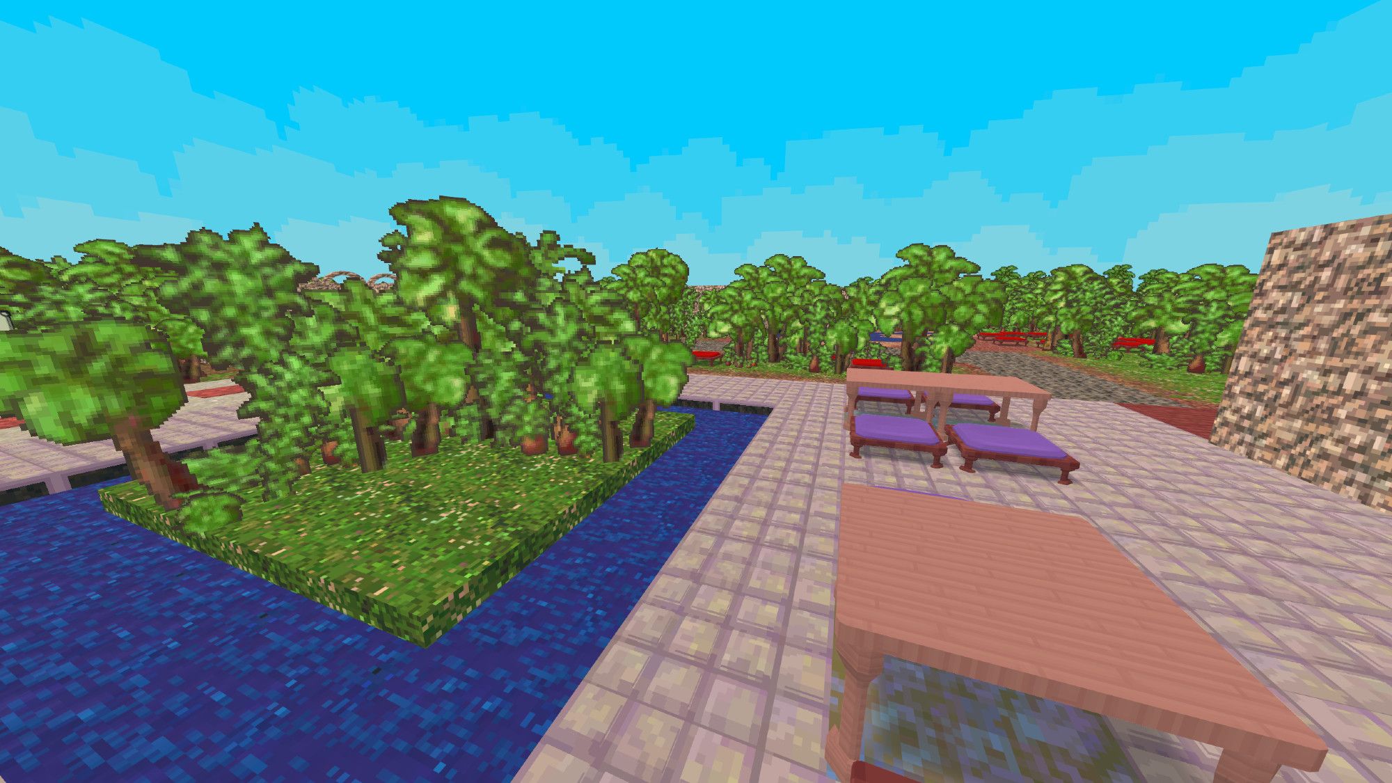 A small pond with an even smaller island, next to some cafe tables. Still in the pixelated 3D look. Trees are off in the distance and help fill in the gaps.