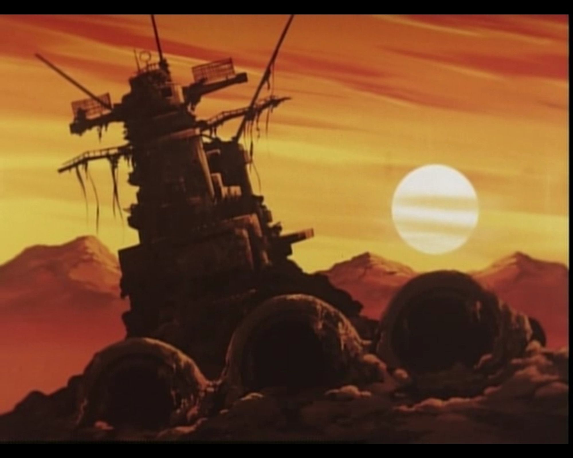 The year is 2199. The Earth's surface has been decimated by radiation bombs from an unknown extraterrestrial foe. What's left of mankind has moved underground. The world war II wreck of the Japanese battleship Yamato rusts in a desert in front of the setting sun.