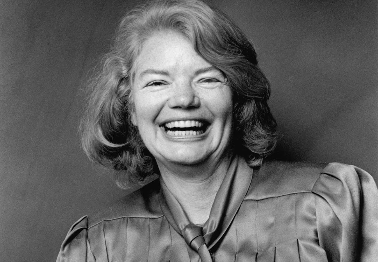 Molly Ivins, dressed in a sort of satin blouse with a neckthing that I'm going to call a scarf?.  She's smiling with every cell in her body.  Beaming radiantly the joy of being righteous and kind at the same time.  Her eyes closed almost to a squint, and every pearly white on display.  Gods bless you, Molly, you were a hell of a person.