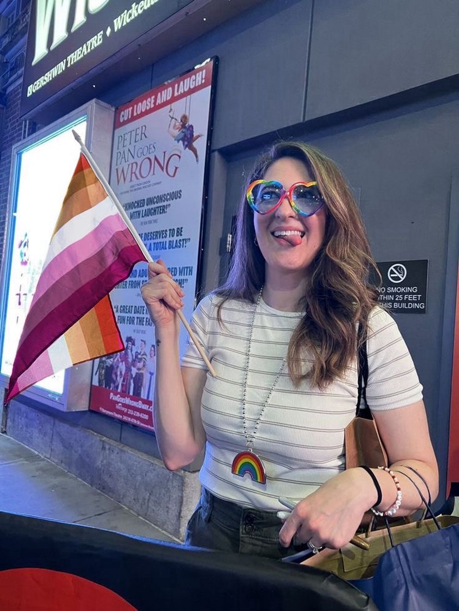 d'arcy carden holding a lesbian flag