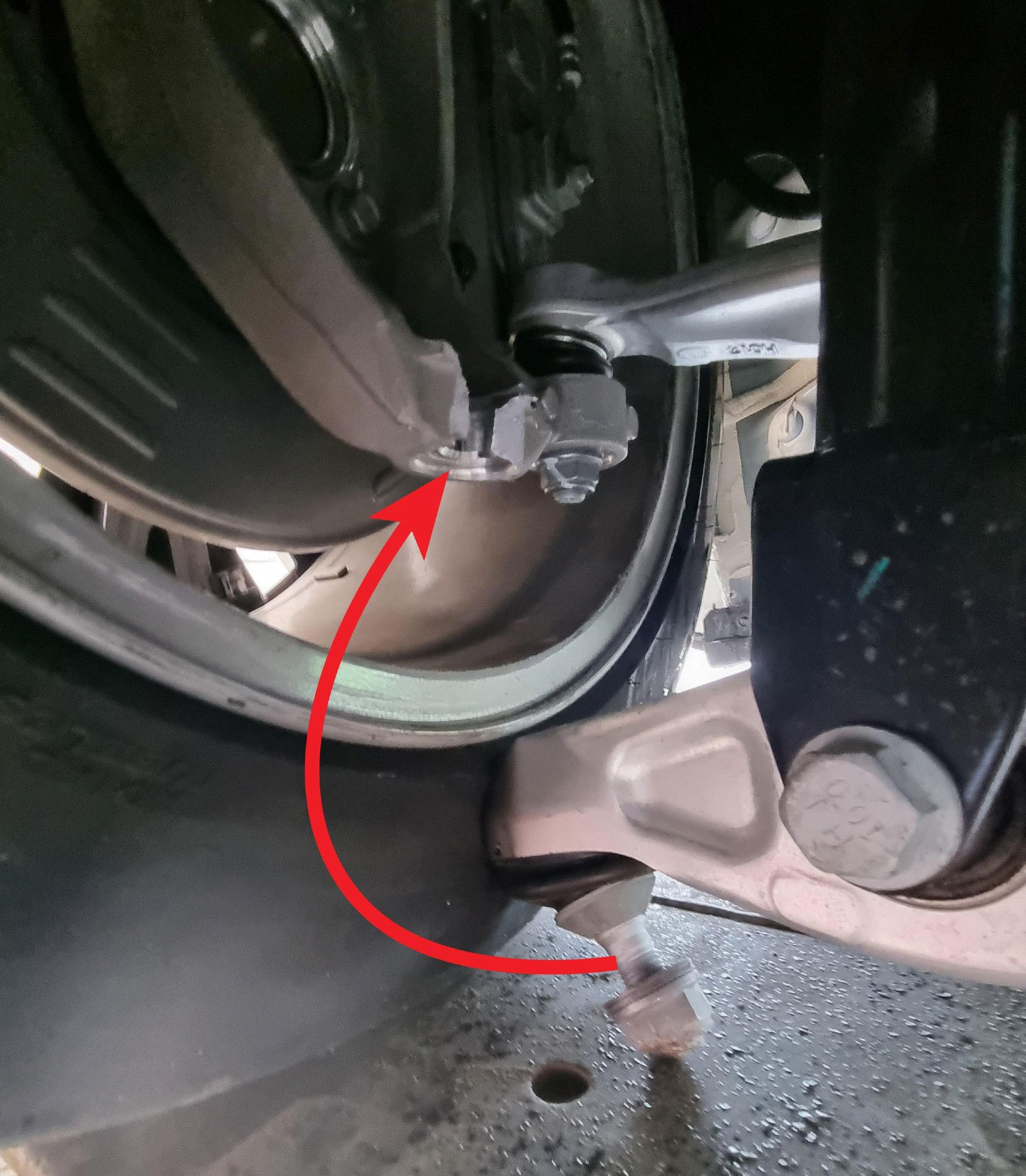 A photo of a broken lower control arm on a 2023 Tesla Model Y that was delivered to a customer only a day prior.