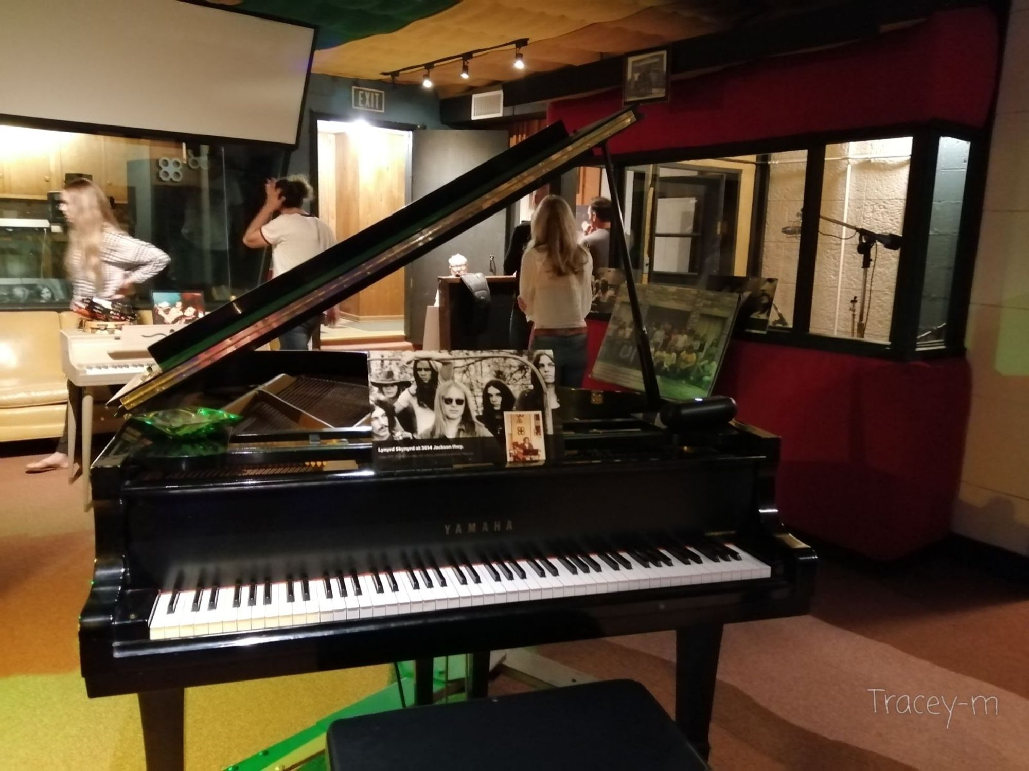 Recording studio with a piano in the foreground with a picture of Lynyrd Skynyrd at the studio