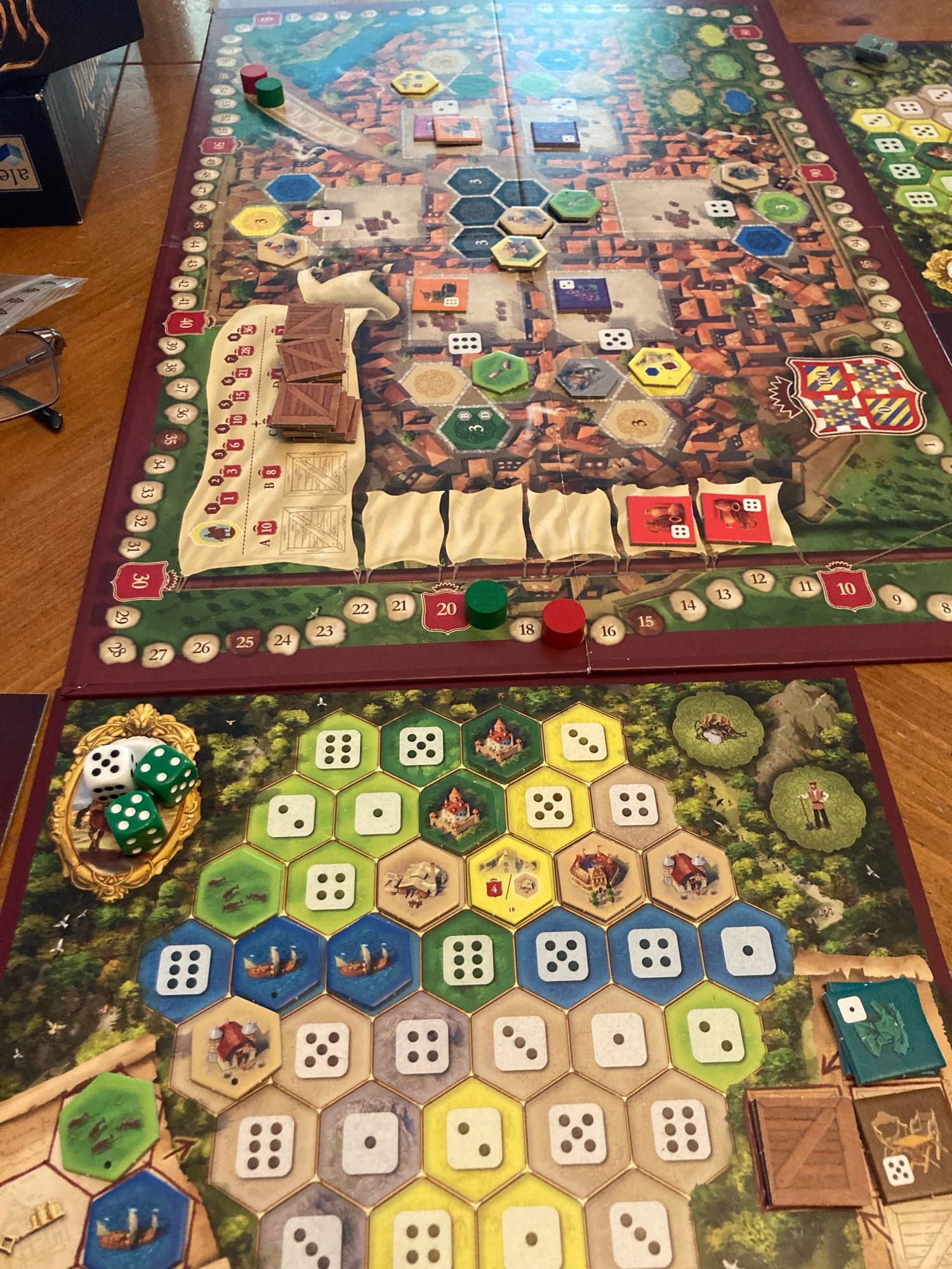 Castles of Burgundy main board and one player board. The player board has a few hexes on it. The main board is set up for Round 2