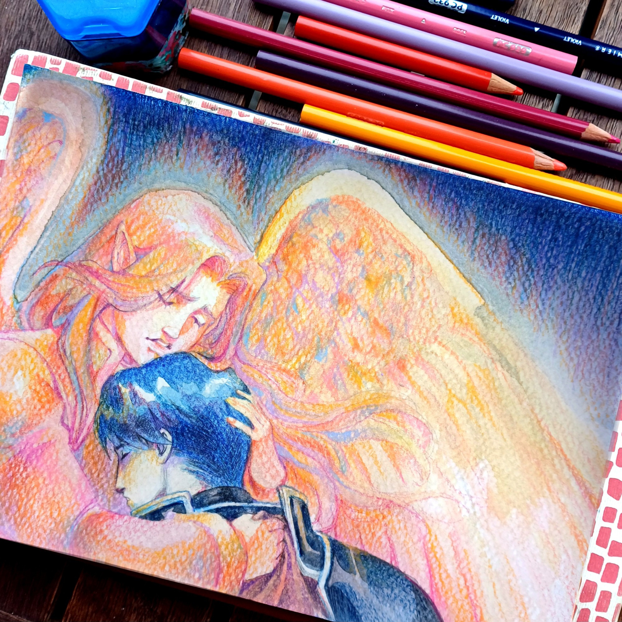 The picture represents a drawing of Sephiran (or Lehran) and Zelgius, two Fire Emblem characters. Sephiran is holding Zelgius in his arms, his face is sorrowful while his companion seems to be sleeping. The drawing is made with watercolors and coloured pencils, and it is saturated and textured. Next to the drawing there are some coloured pencils.