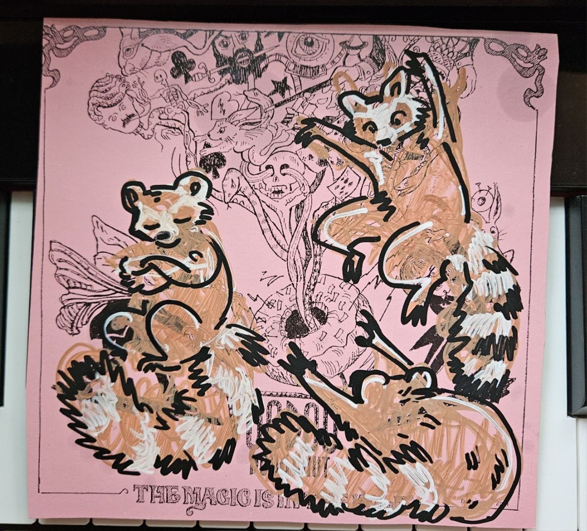 A sketch of 3 raccoons on a Voodoo Donuts box lid.