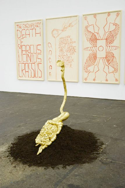 an artwork featuring a golden cast of a human digestive tract, referencing the legend of the death of Marcus Licinius Crassus.
Source: http://ag-archives.net/fr/projets_ab_crassus 
