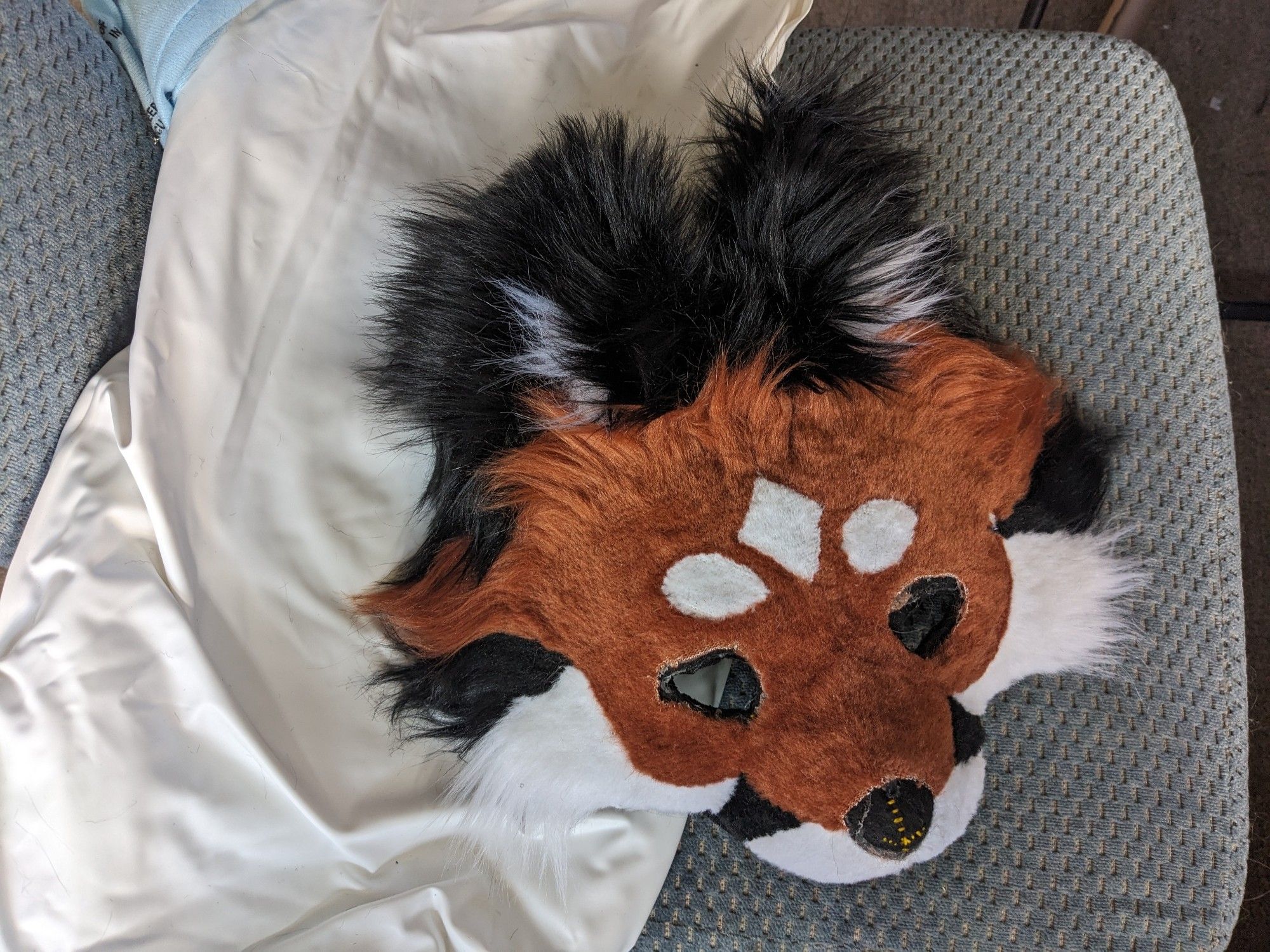 A wip red fox half mask with very fluffy black ears