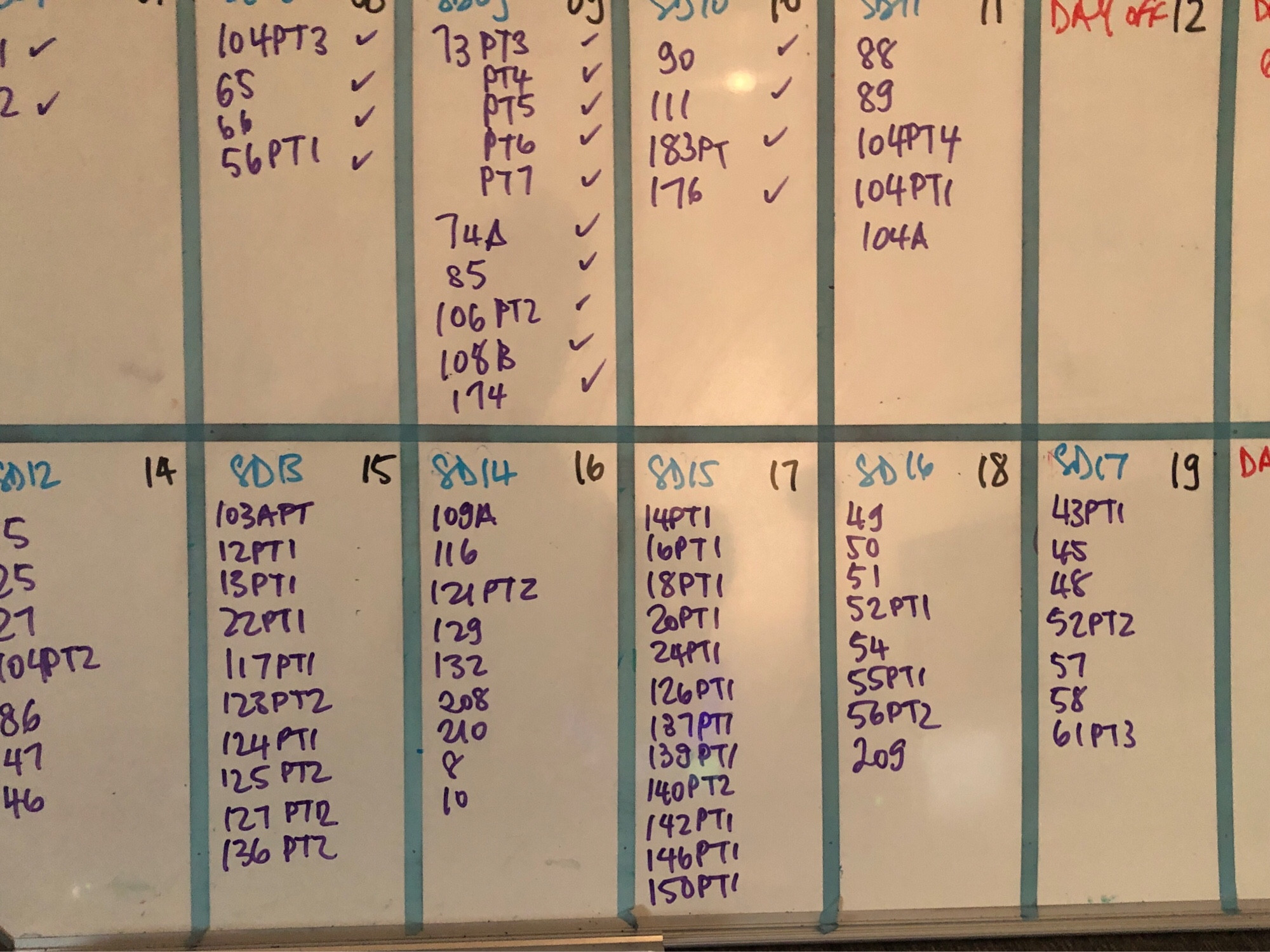 a whiteboard with all the scenes to be shot next week listed on it. board is full full