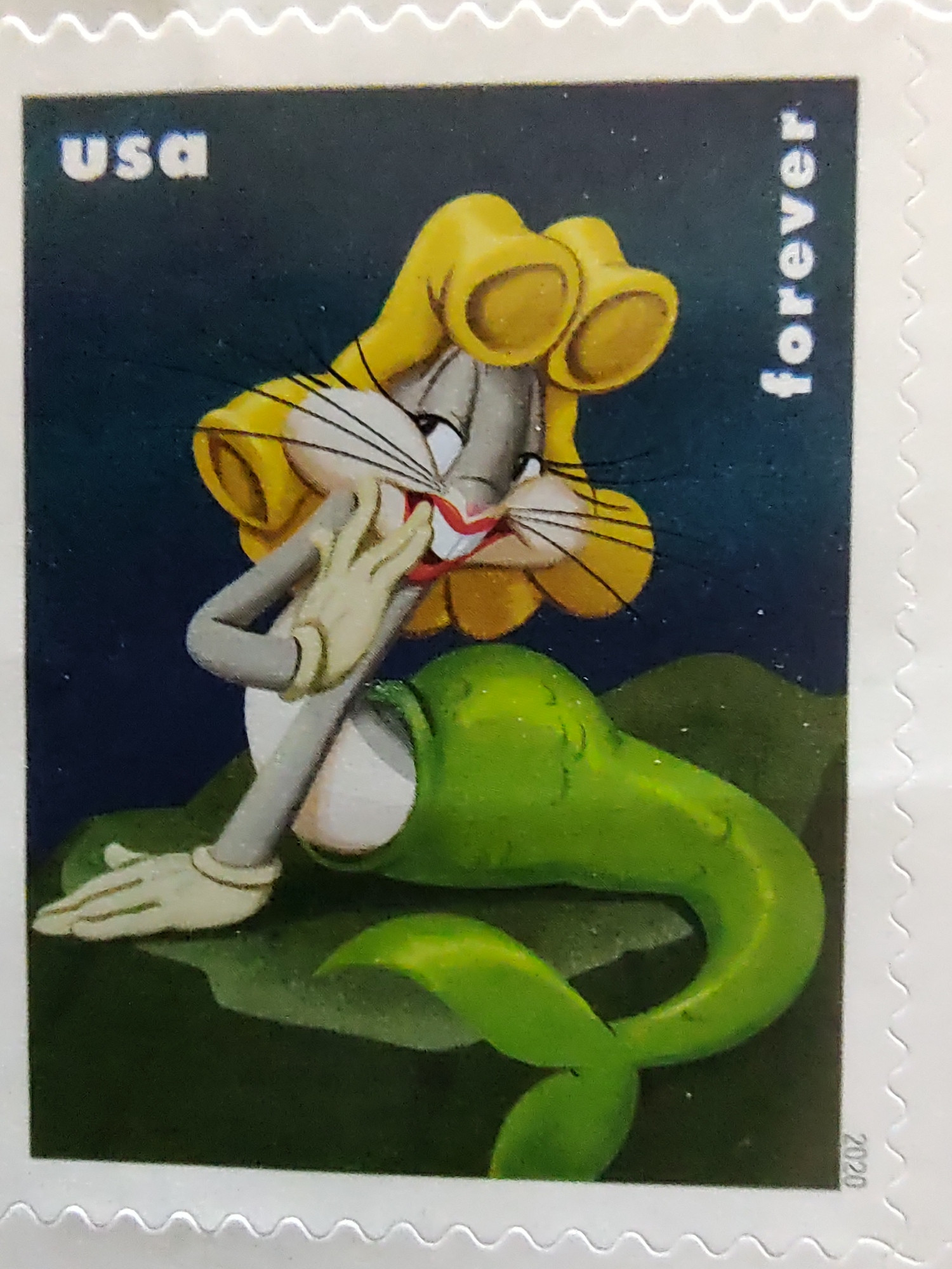 Bugs Bunny dressed as a mermaid with a blond wig on a forever stamp