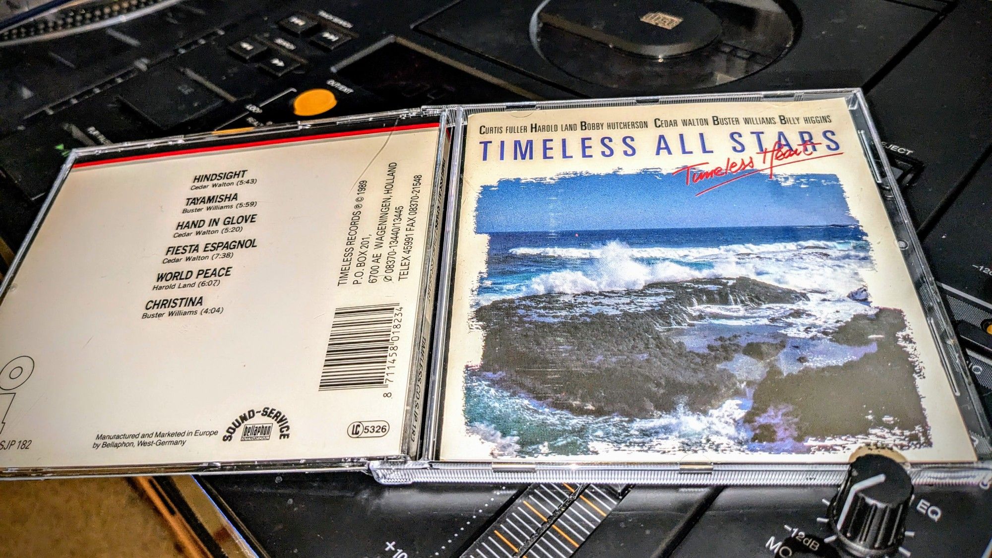 opened jewelcase front and back side of "Timeless All Stars - Timeless Heart" on, you guessed right, Timeless Records, presented on the Pioneer CDJ. cover shows crashing waves on the rocky shore.