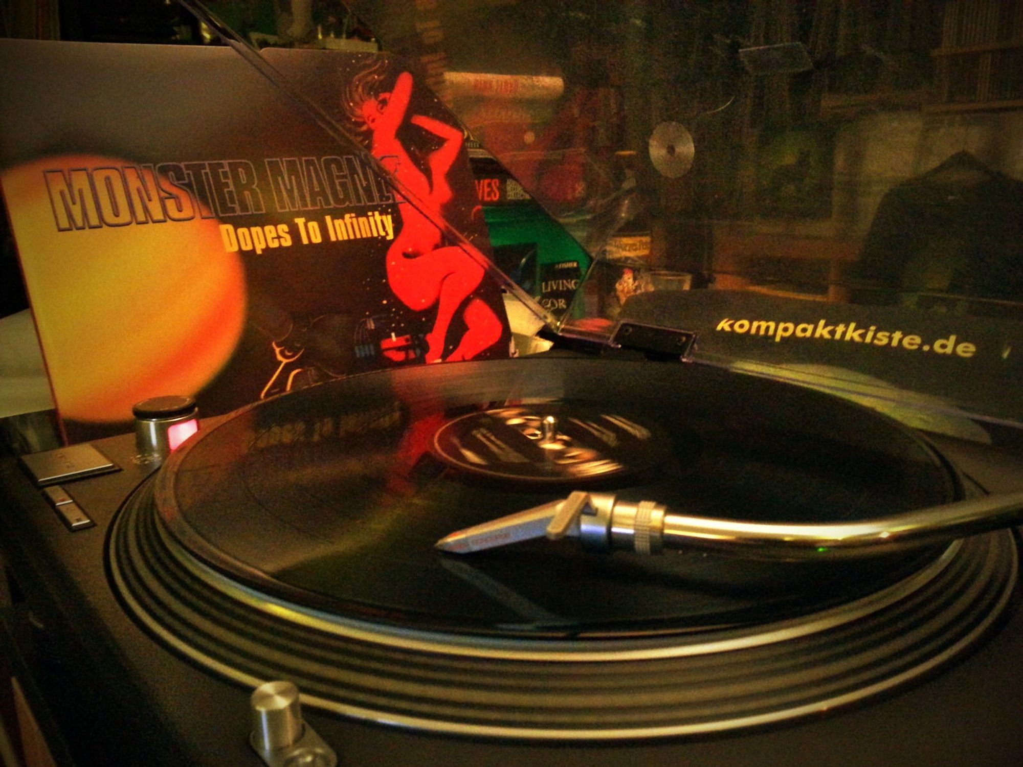 "Monster Magnet - Dopes To Infinity" 2012 reissue vinyl record playing on the Technics, cover showing a yellow sun and a red lady behind it.