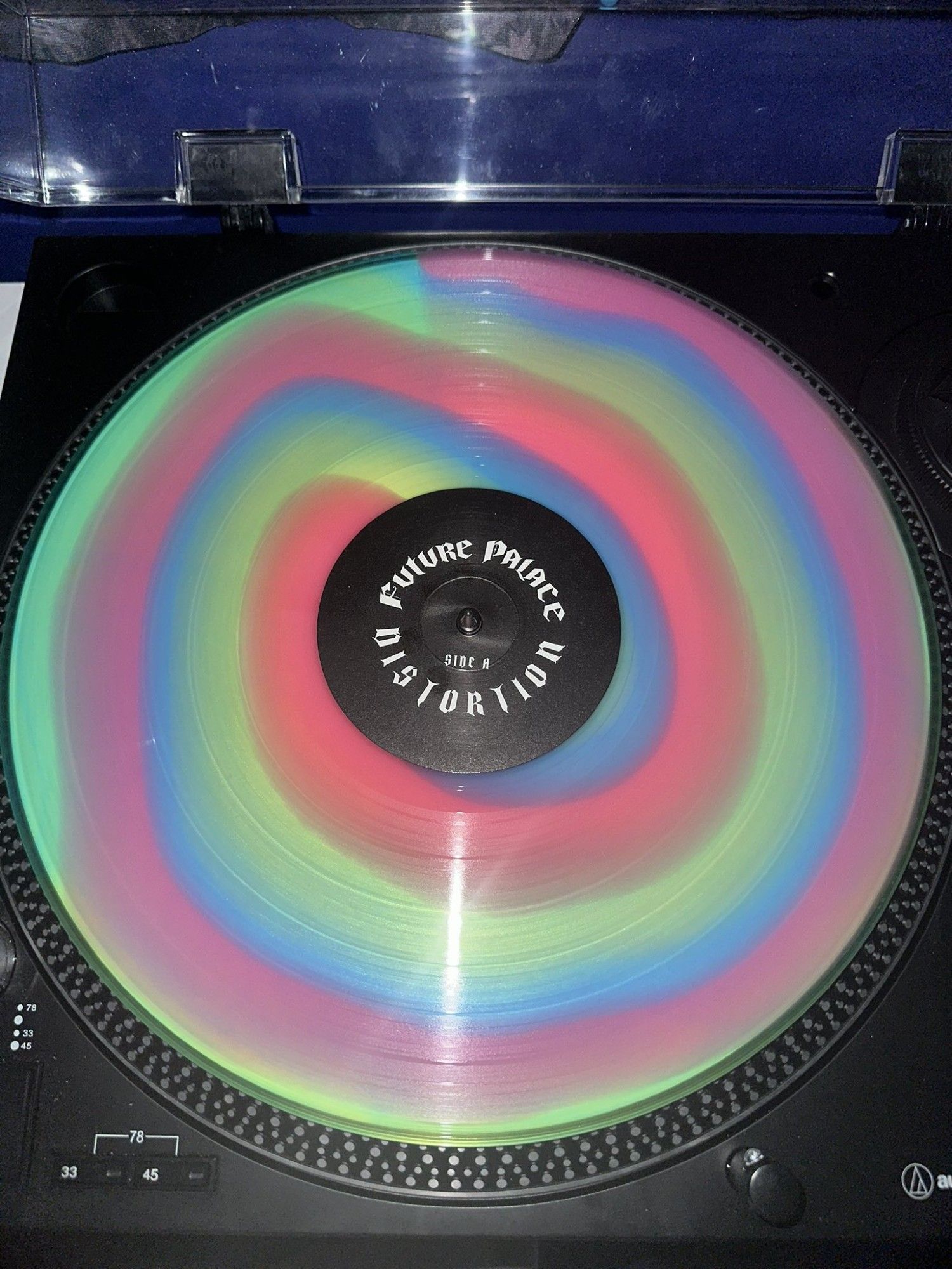 vinyl record coloured with red/blue/green stripes running from the inside out, variant called "twister"