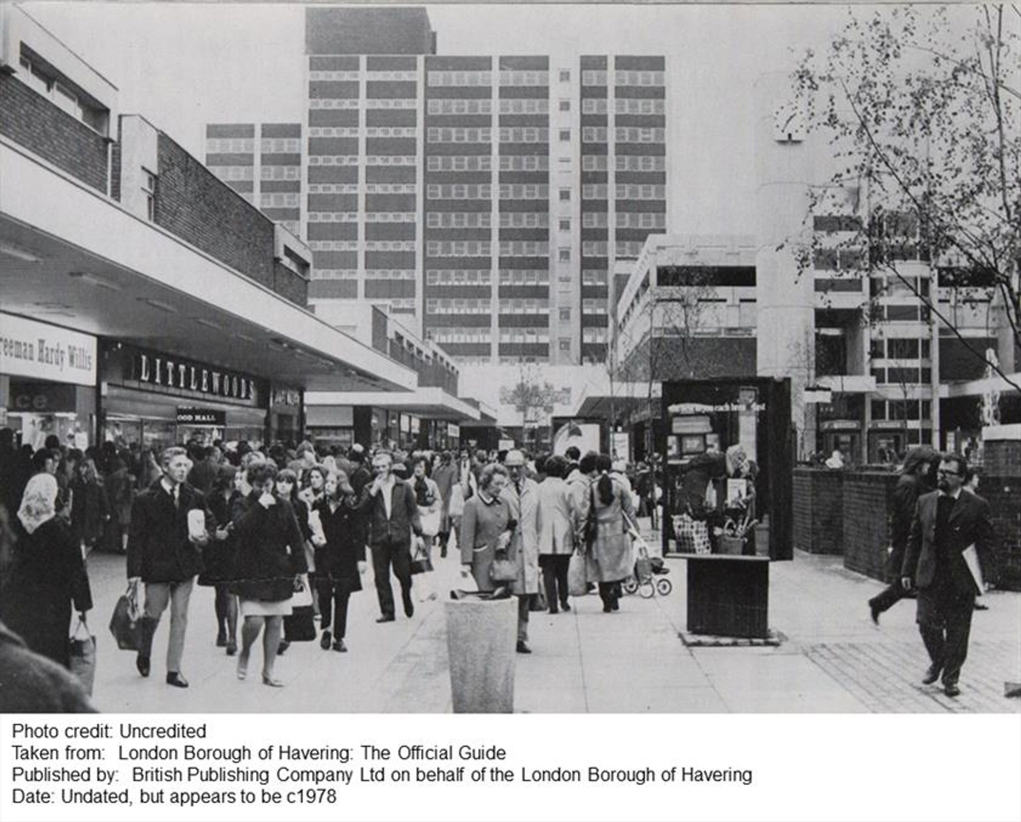 A black and white photo of a modern open air shopping with a tower block in the distance.

Photo credit: Uncredited
Taken from: London Borough of Havering: The Official Guide
Published by: British Publishing Company Ltd on behalf of the London Borough of Havering
Date: Undated, but appears to be c1978