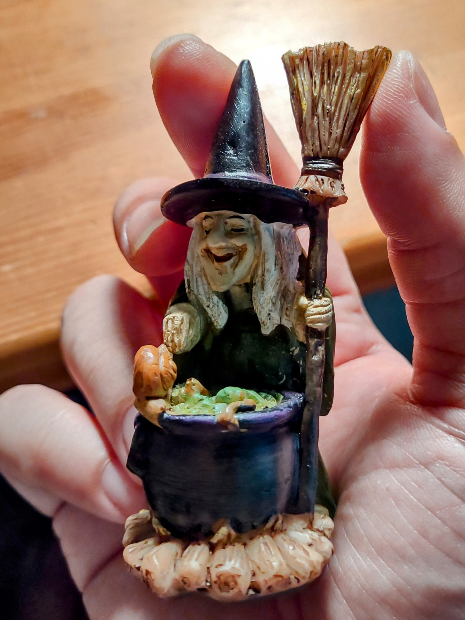 Small Witch figurine with a cauldron and a broom. 