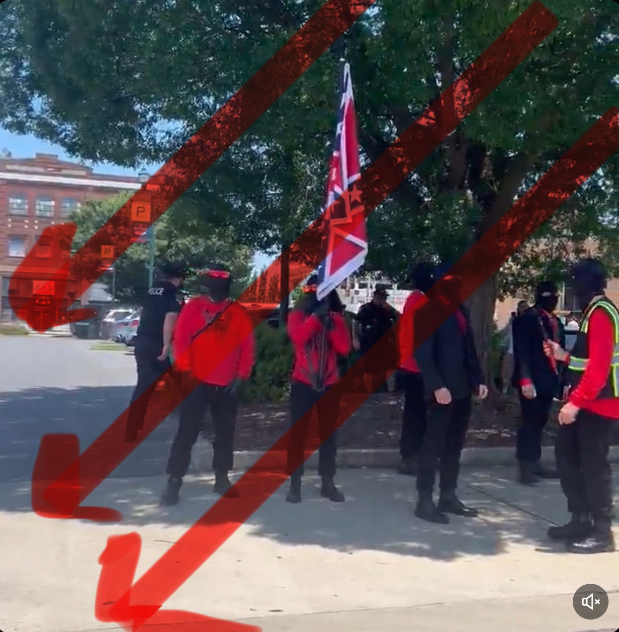 About six Nazi chuds wearing red and black including. Blood tribe logo on some shirts 