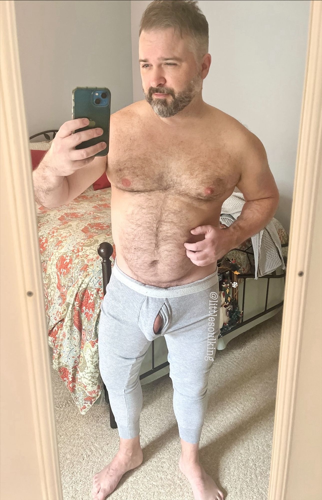 Furry middle-aged man wearing only tight grey long johns. My soft dick is slightly visible through the opening in front.