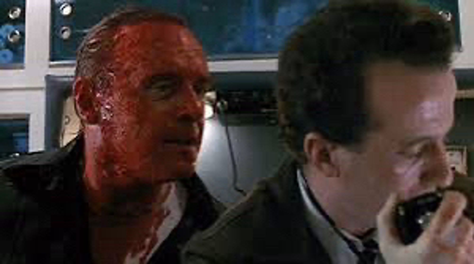 Hannibal Lecter standing behind a man. He has just removed the face he was wearing and his own face is covered in blood