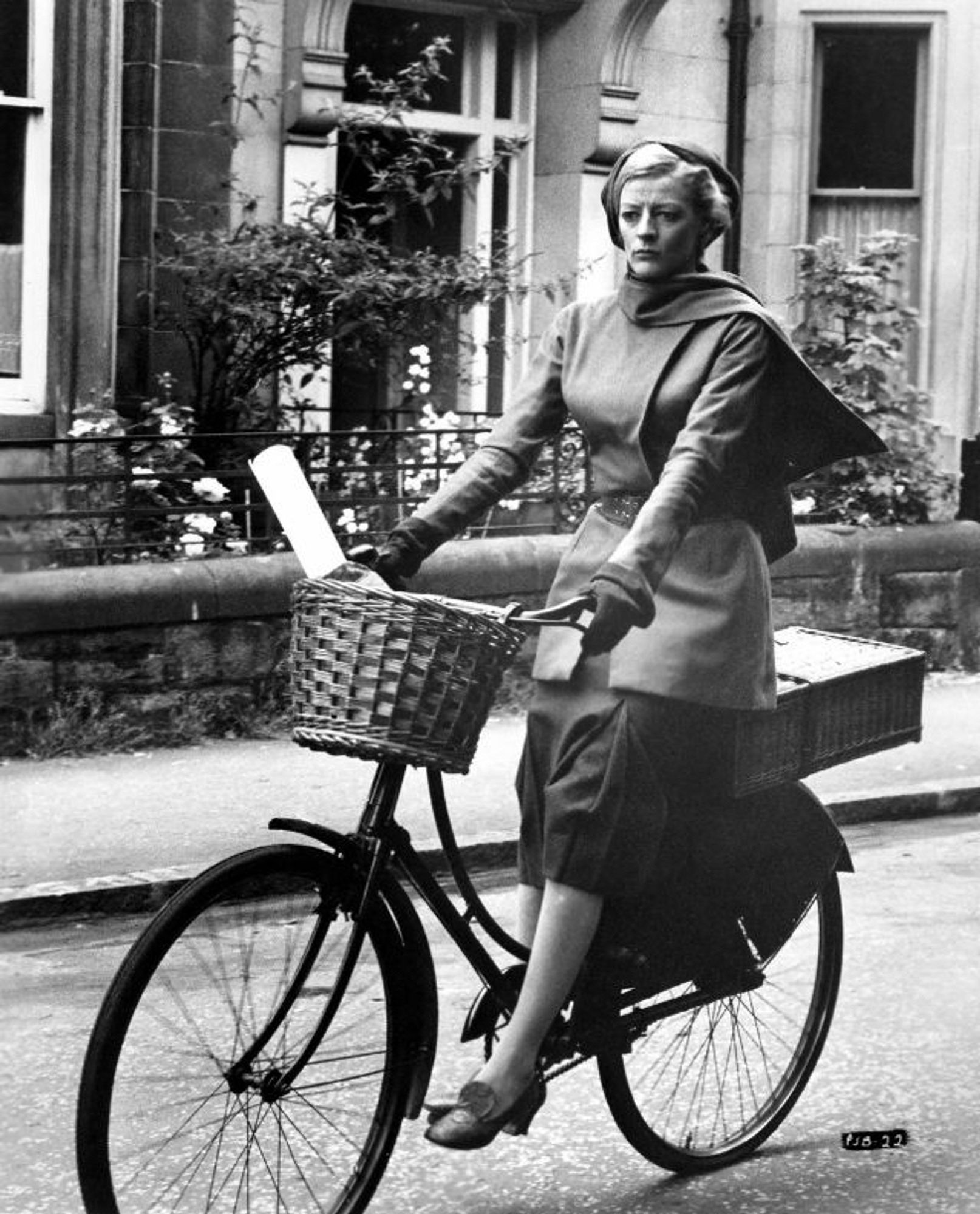 monochrome photo of Maggie Smith, a white woman, on a bicycle