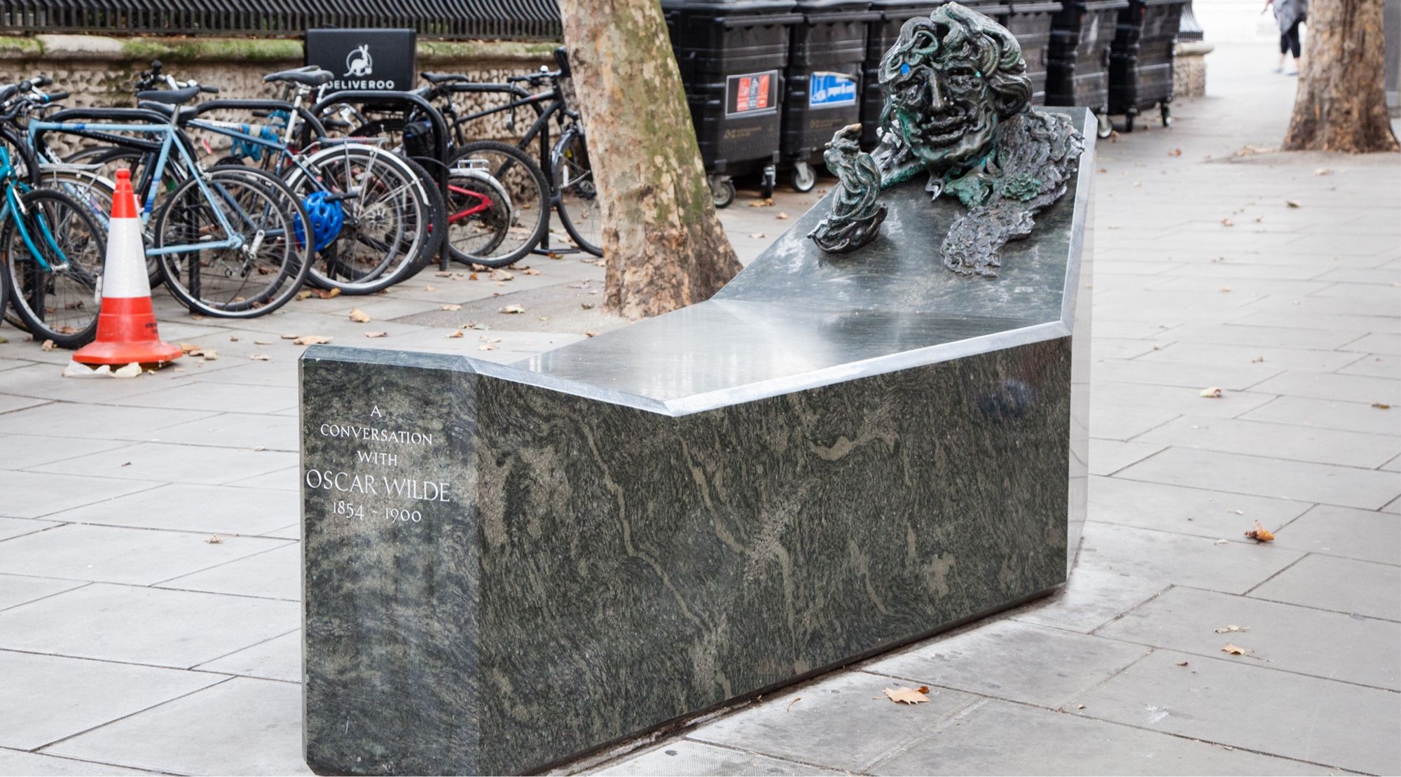 A sculpture by Maggie Hambling entitled, A Conversation with Oscar Wilde. A bronze head and hands of Wilde, confected to look like an idle, scribbly drawing, emerge bizarrely from one end of a coffin-like polished granite sarcophagus. It is situated in a pedestrian cut-through behind St Martin’s church. An unlovely modern pissoir has latterly been installed close by, in an attempt to discourage drunk men from urinating on it.