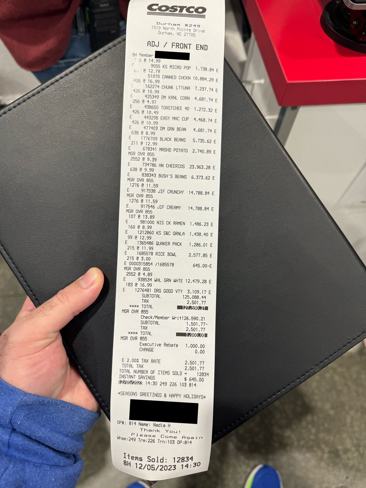 Photo of receipt from Costco that is roughly 13" in length, showing 12,834 items purchased for $127,590.21 USD