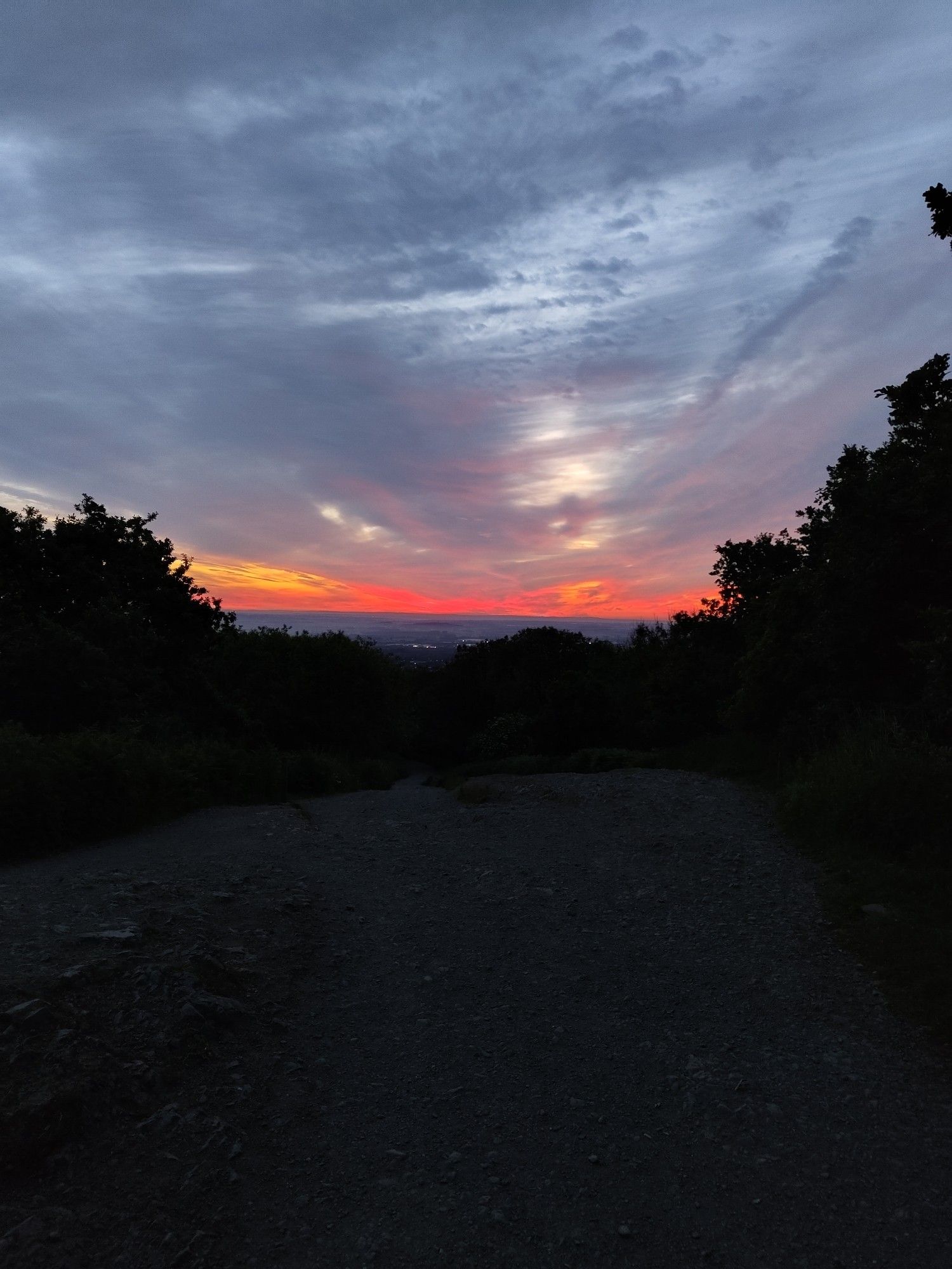 A red-orange glow extends from the horizon as the sun begins to rise.