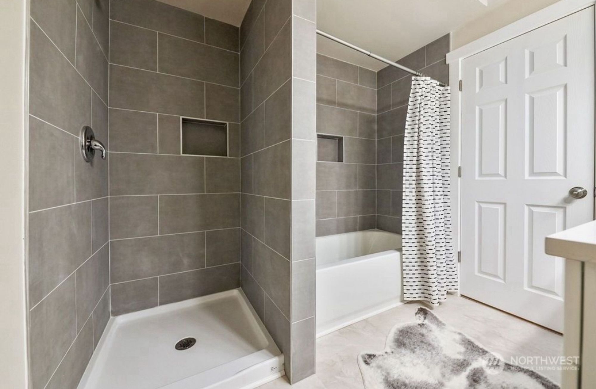 Shower next to tub/shower combo.