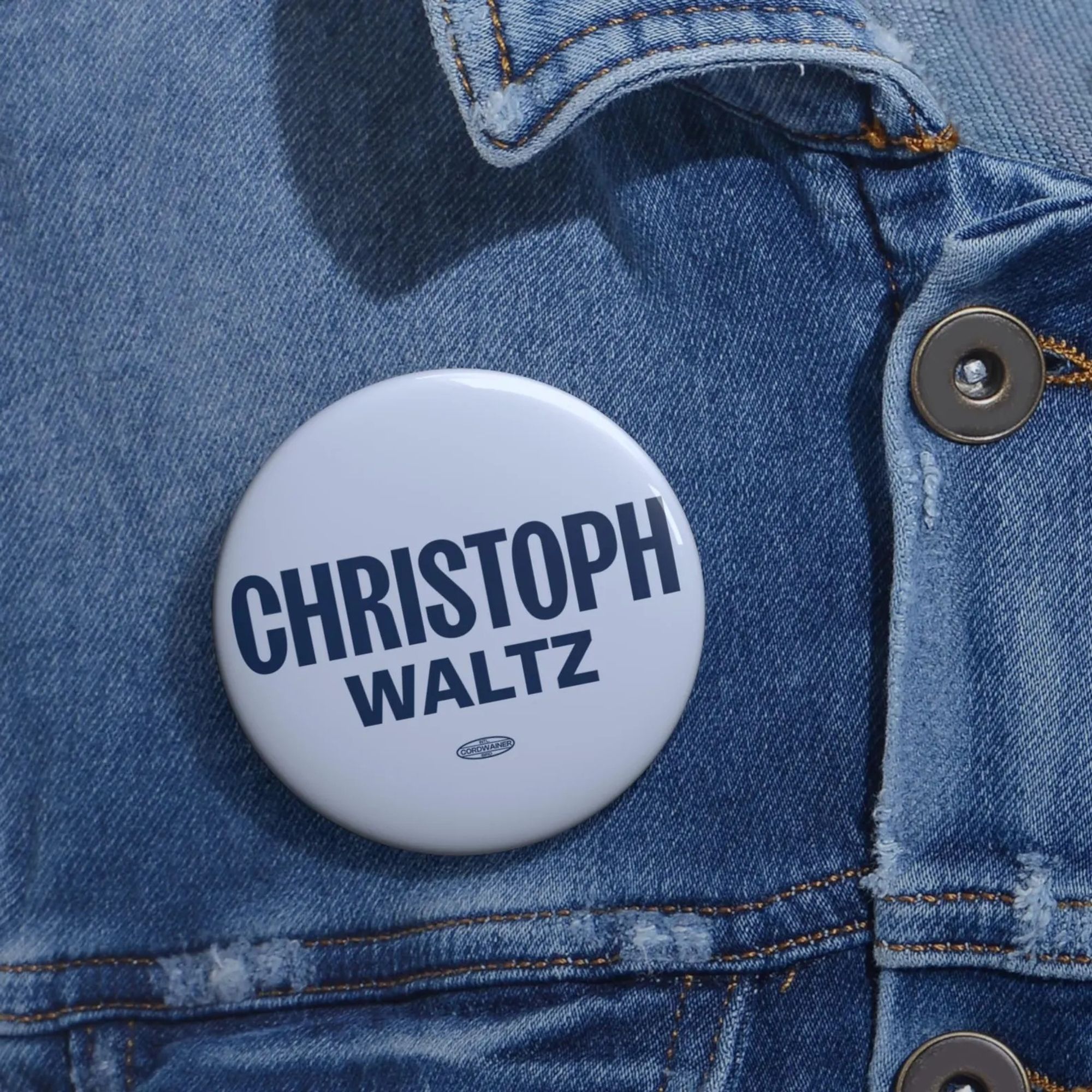 Closeup of button reading CHRISTOPH / WALZ in the style of the HARRIS / WALZ campaign logo.