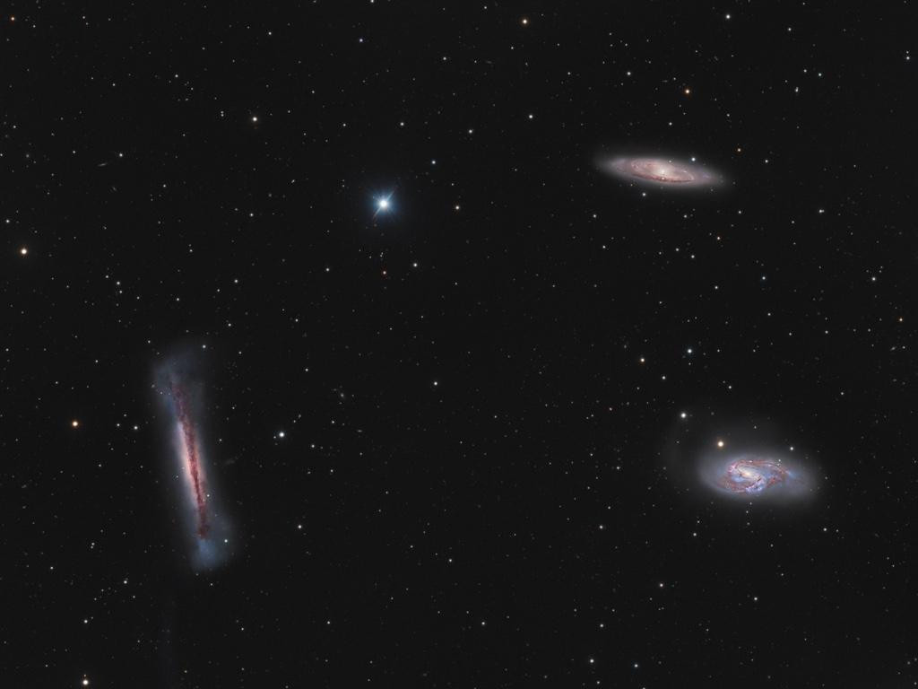 A stunning view of the Leo Triplet, a group of three galaxies: NGC 3628 (seen edge-on, left), M66 (bottom right), and M65 (top). All three are spiral galaxies but look different due to their angle relative to Earth. The gravitational interactions between them have created telltale signs, including a warped NGC 3628 and drawn out spiral arms of M66. The field spans about one degree and covers over 500 thousand light-years at the trio's distance of 30 million light-years.