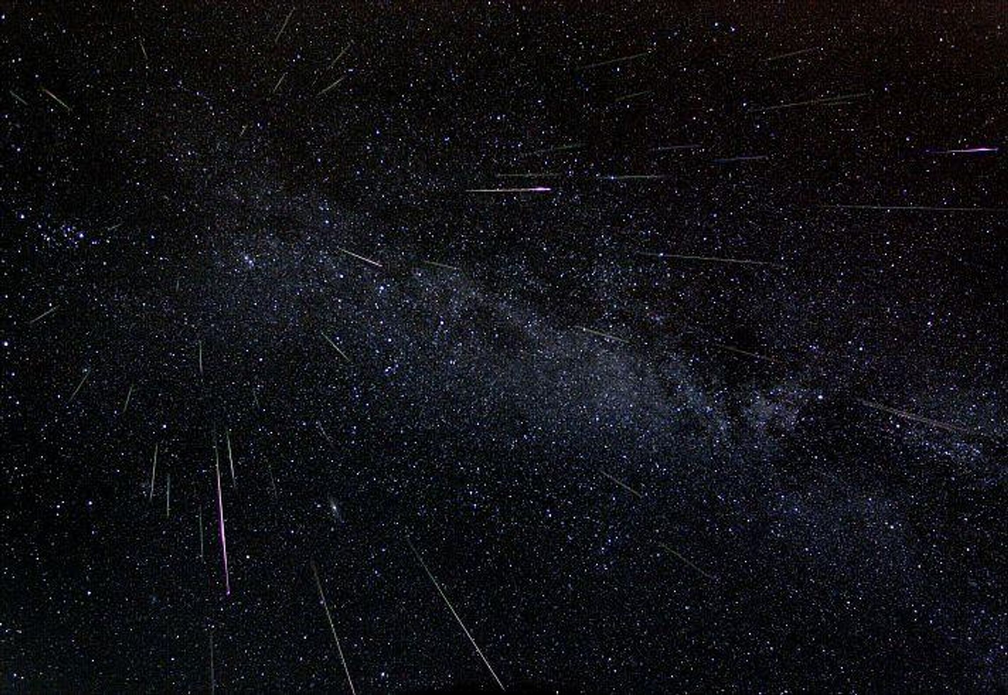 A composite image of the Perseid meteor shower, captured over 6 hours on August 11-12, 2022. The image shows 51 Perseid meteors streaking across the night sky, converging towards the radiant point in the constellation Perseus. The Milky Way is visible across the image, along with a vast expanse of stars. The image was taken using a wide-angle lens and a series of 30-second exposures.