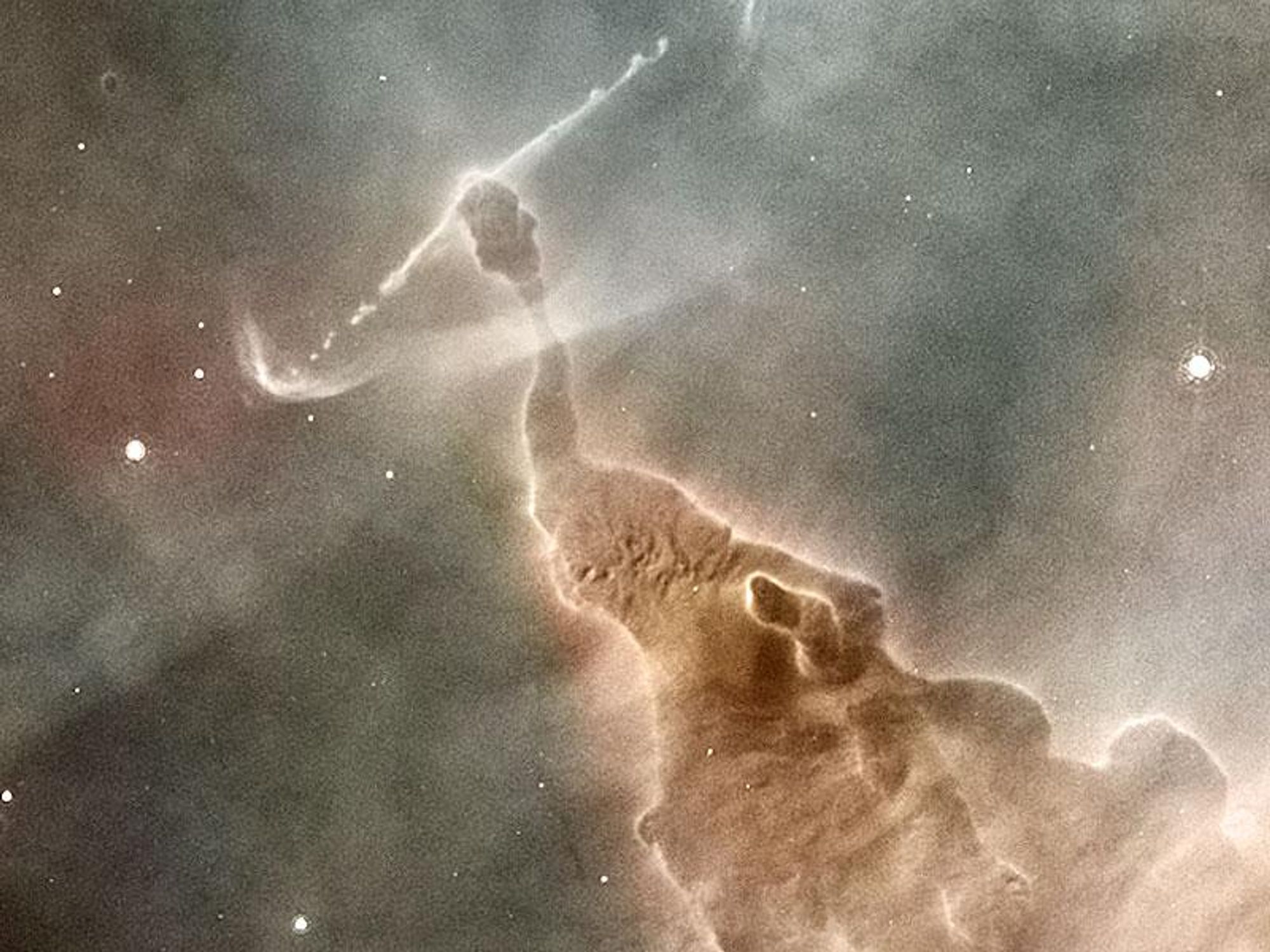 A close-up of a pillar of gas and dust in the Carina Nebula being eroded by a star within it.  The star, not visible in the image, is creating powerful jets of particles that are sculpting the pillar.  Over time, the star will completely destroy the pillar, but will also lead to the creation of a new open cluster of stars.  The image is a small portion of a larger mosaic taken by the Hubble Space Telescope.