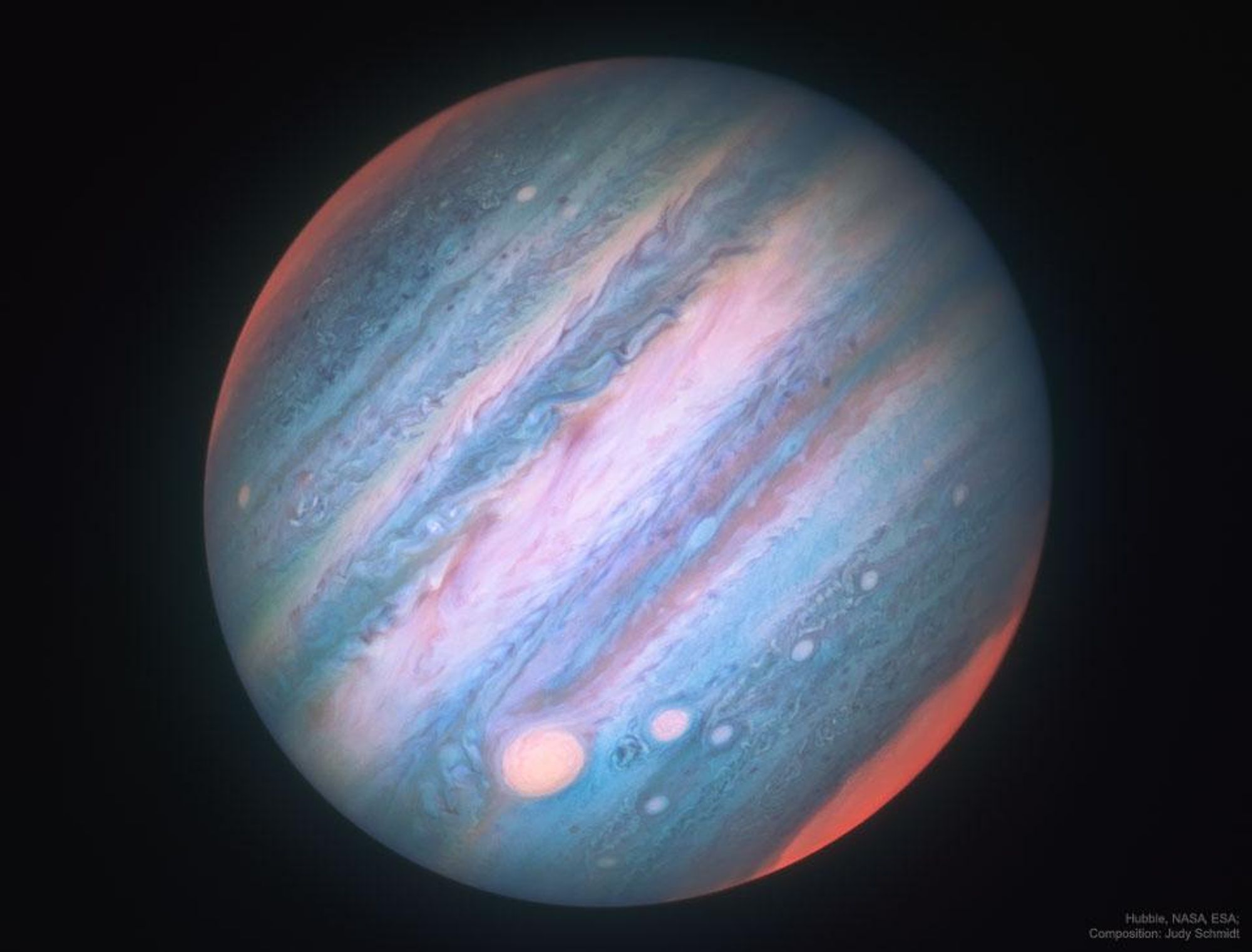 A stunning infrared image of Jupiter captured by the Hubble Space Telescope. The image reveals the planet's intricate cloud patterns, with the Great Red Spot, string-of-pearls storm systems, and bright polar regions.  The colors of Jupiter being monitored go beyond the normal human visual range to include both ultraviolet and infrared light.  The infrared image was digitally reassigned into a mapped color image.  The different shades of color depict different temperatures and cloud heights.