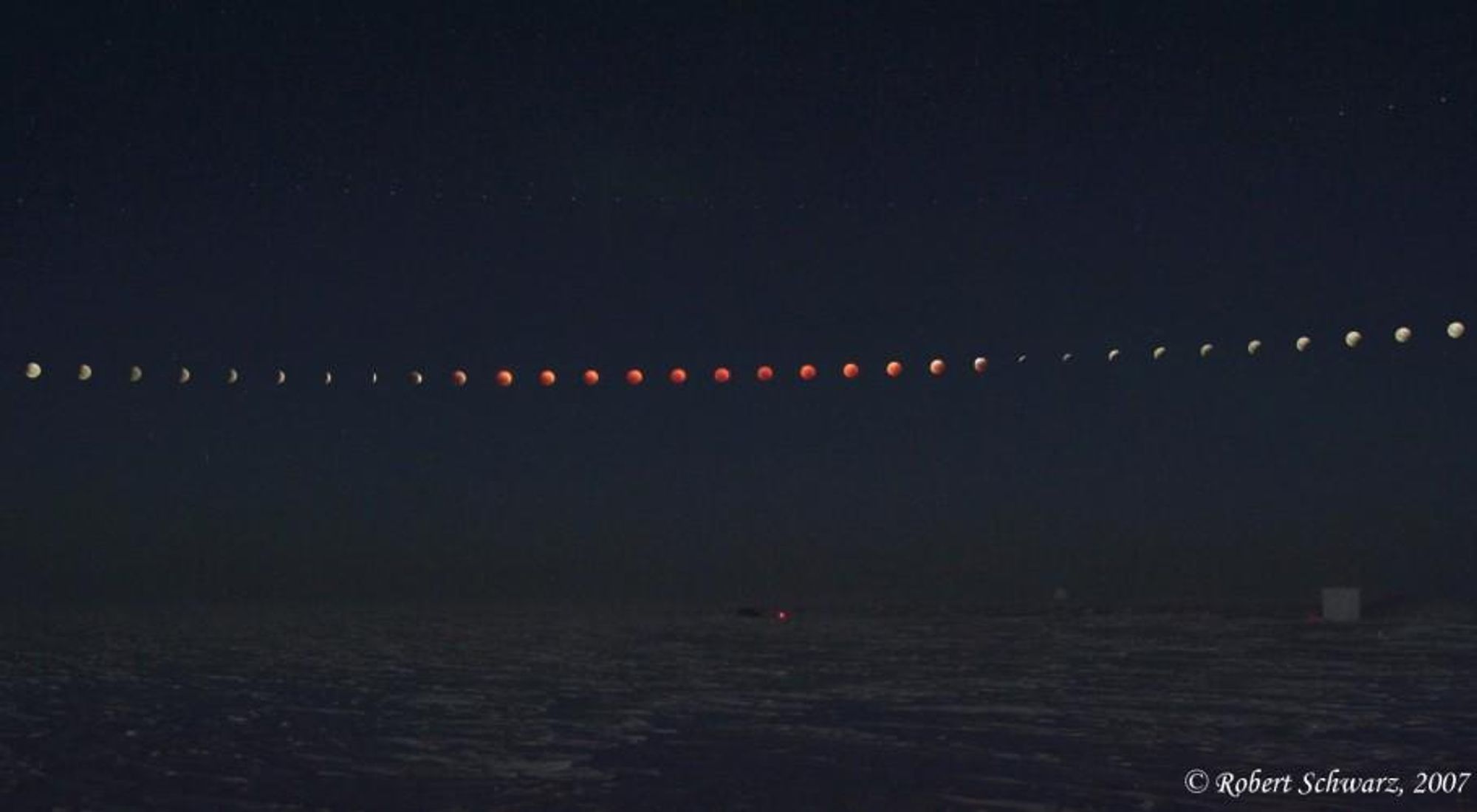 A timelapse of the total lunar eclipse on August 28, 2007, taken from the South Pole. The moon appears to move across the sky as it goes through the different phases of the eclipse, with the Earth's shadow casting a reddish hue on the moon. The image was taken by Robert Schwarz, who had to brave frigid temperatures to capture this incredible spectacle.