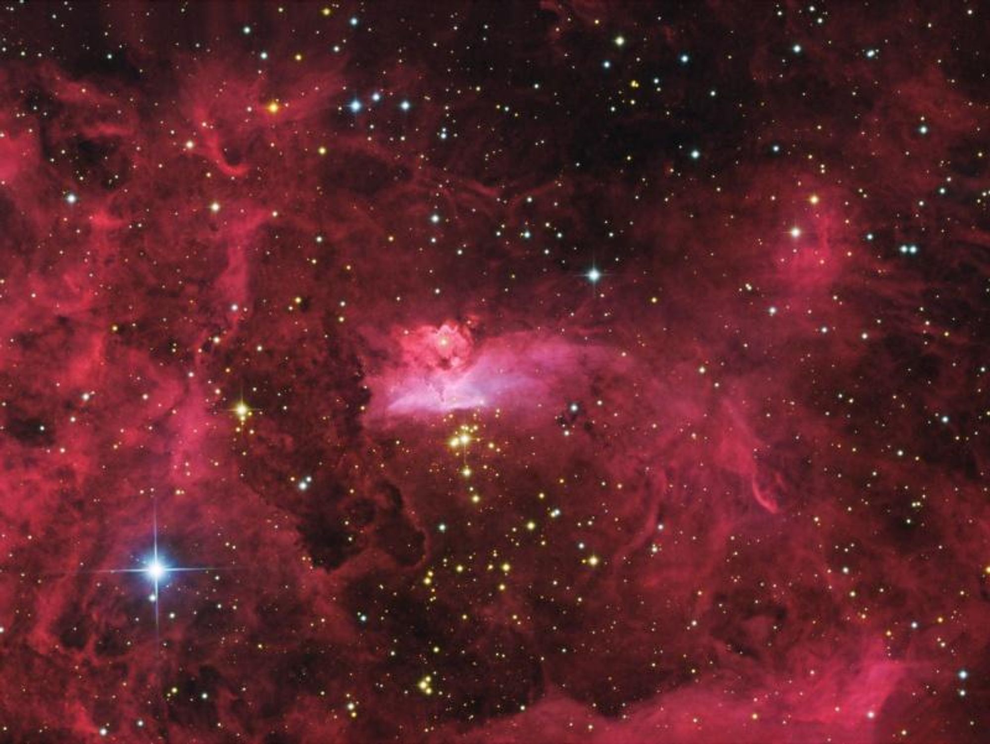 A stunning close-up of the emission nebula NGC 6357, located in the constellation Scorpius, showcasing the intricate shapes carved by interstellar winds and energetic radiation from young and massive stars. In the center, the star cluster Pismis 24 contains some of the most massive stars known in our galaxy, with some over 100 times the mass of the Sun. Dusty pillars of molecular gas, likely hiding massive protostars, are also present in the bright central region. The image spans just under 50 light-years across.