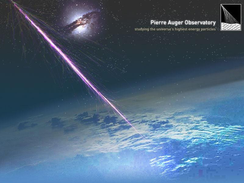 An illustration of a cosmic ray striking the Earth's atmosphere and creating a shower of secondary particles, with the active galaxy Centaurus A shown in the background, implying a possible origin for the cosmic ray. The text reads "Pierre Auger Observatory studying the universe's highest energy particles."