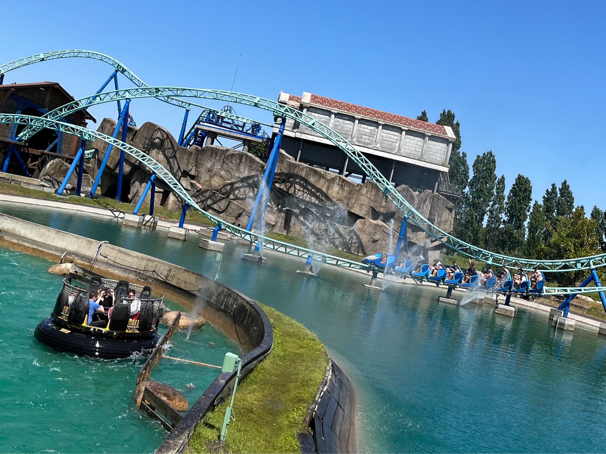 Photo of Pégase Express and Romus et Rapidus, a steel roller coaster and a river rapids ride, both located in Parc Astérix in France.