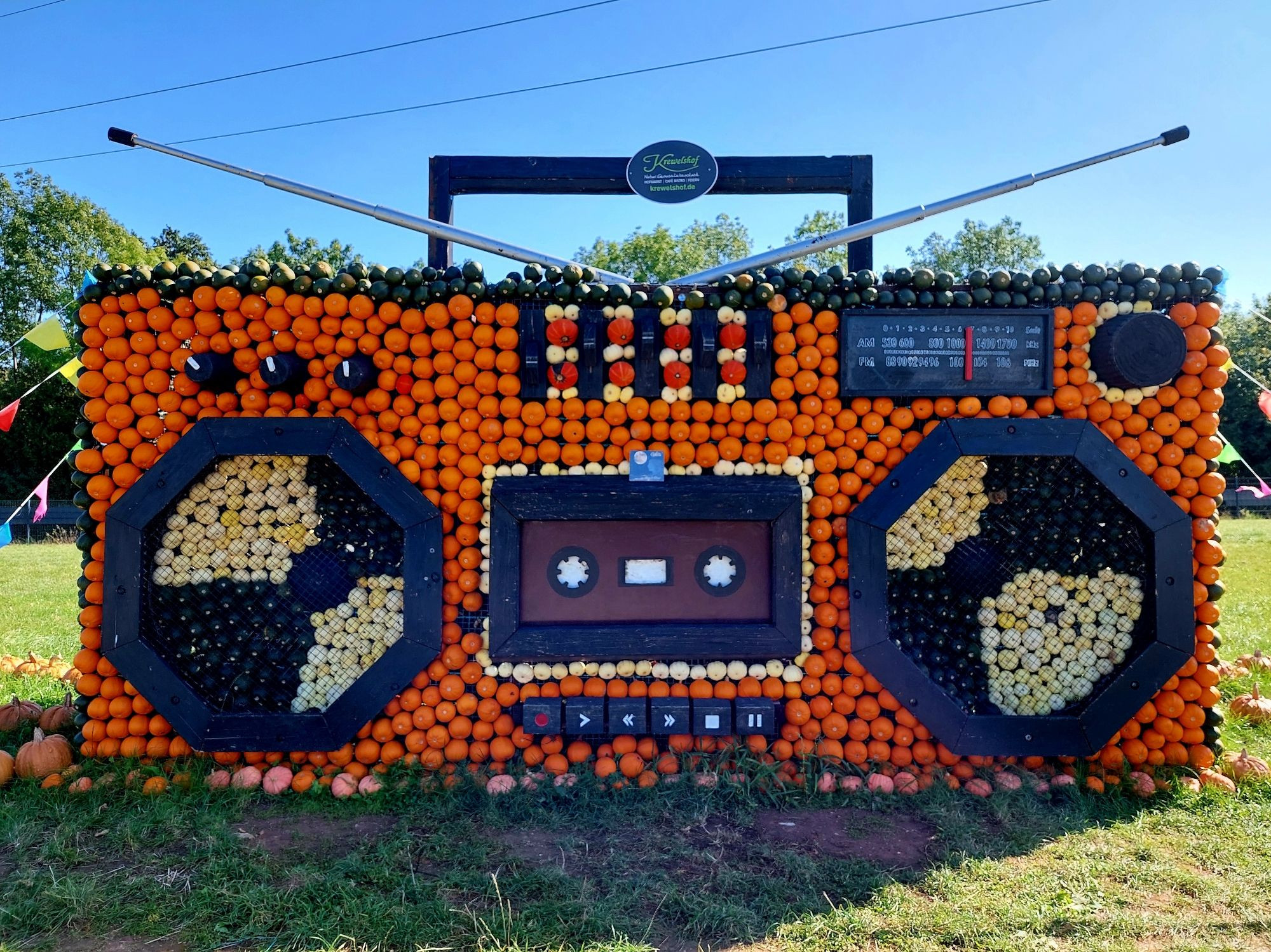 Photo of a human-sized ghettoblaster made out of pumpkins