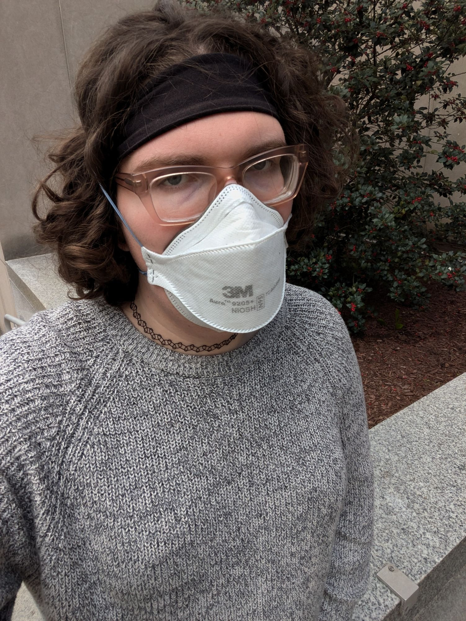 selfie of thom, a transsexual, wearing glasses, mask, and a black and white sweater