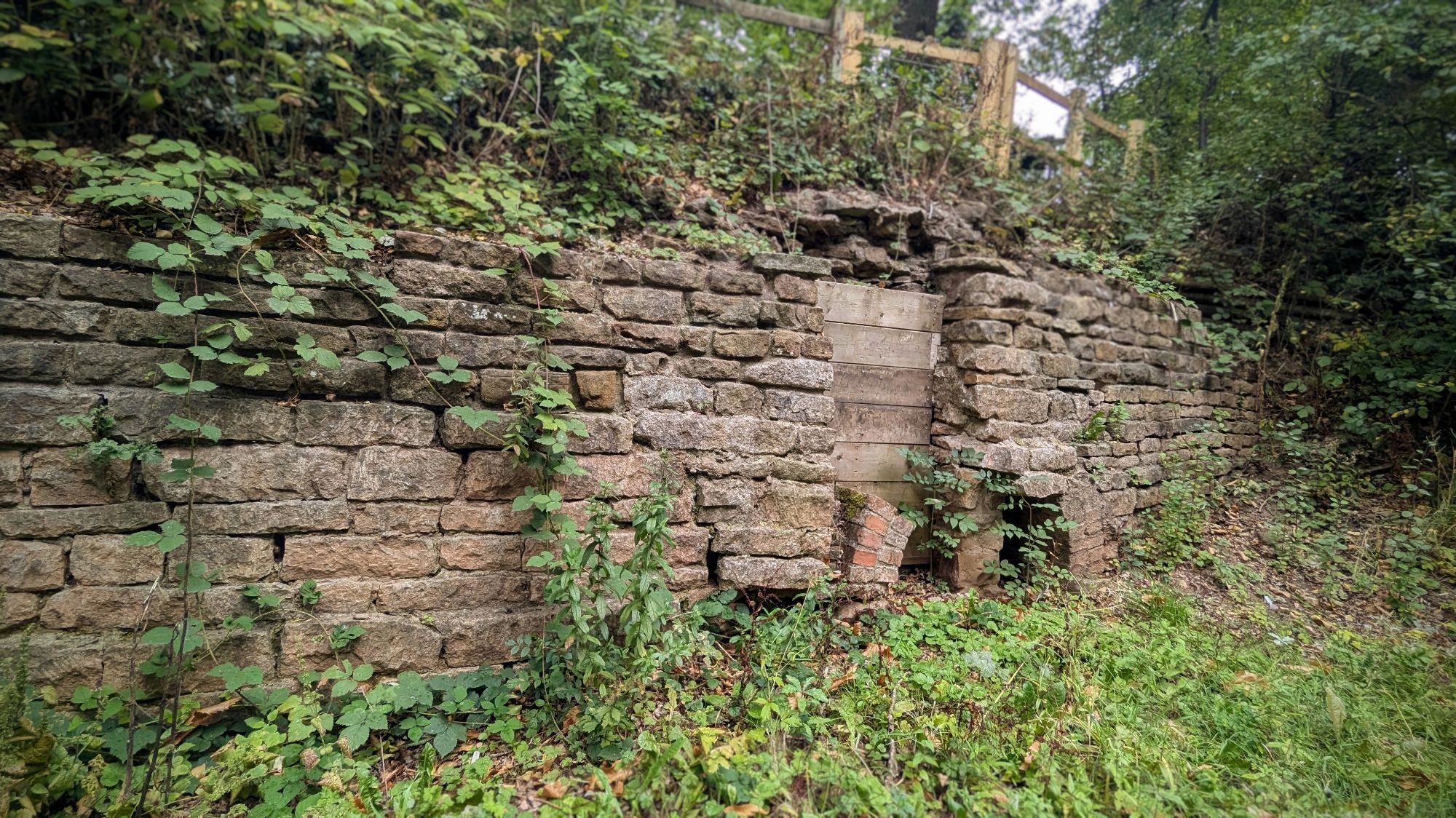 A stone structure stretches across an embankment. In the centre, at ground level, an arch can be seen. Excavations at the site (details in the URL in the skeet) revealed remains of wood and nails, suggesting a wooden structure then carried the water across the road (over or under is uncertain).