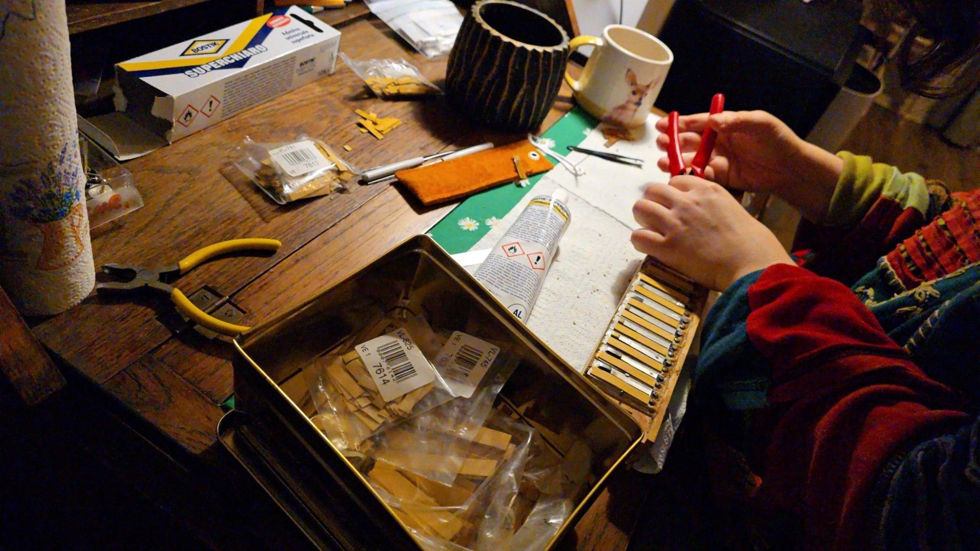 An accordion reed block being given new reed leathers.