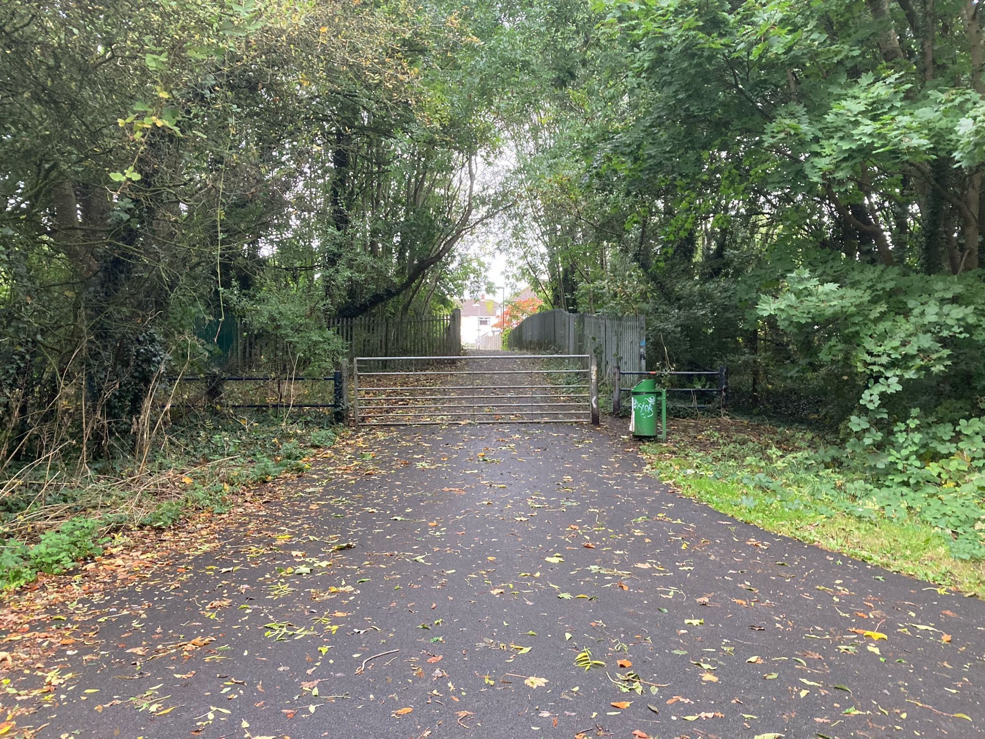 A gate obstructing an access route off a wide shared use path. This path is part of the national cycle network