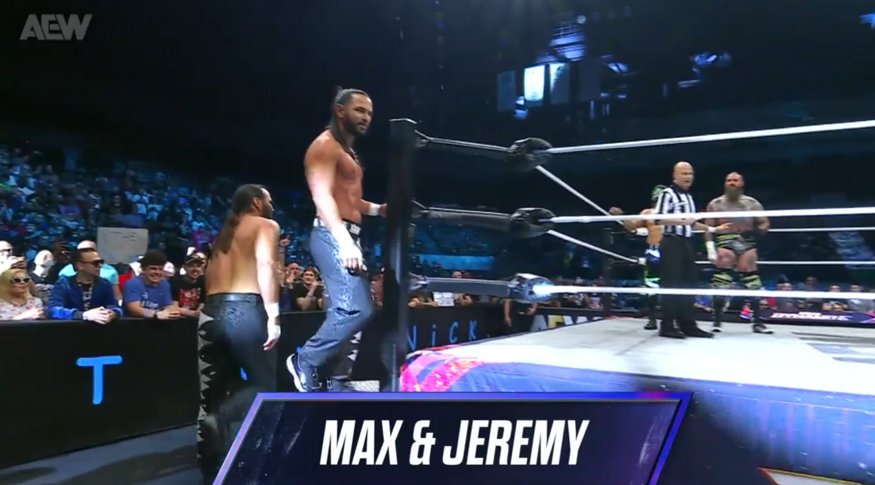 The Young Bucks entering the ring, their chevron titles them "Max&Jeremy"