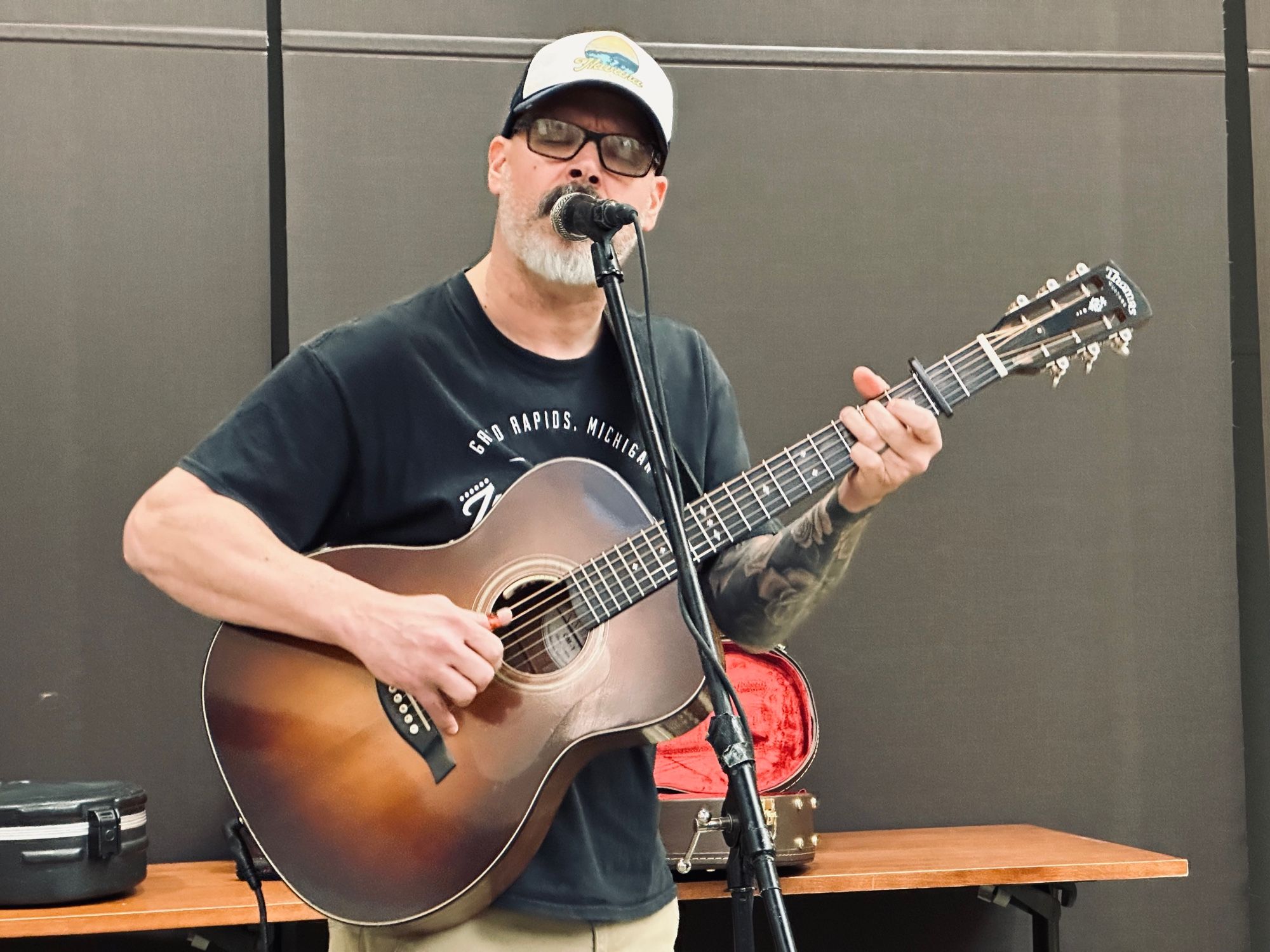 Edward David Anderson playing guitar and singing