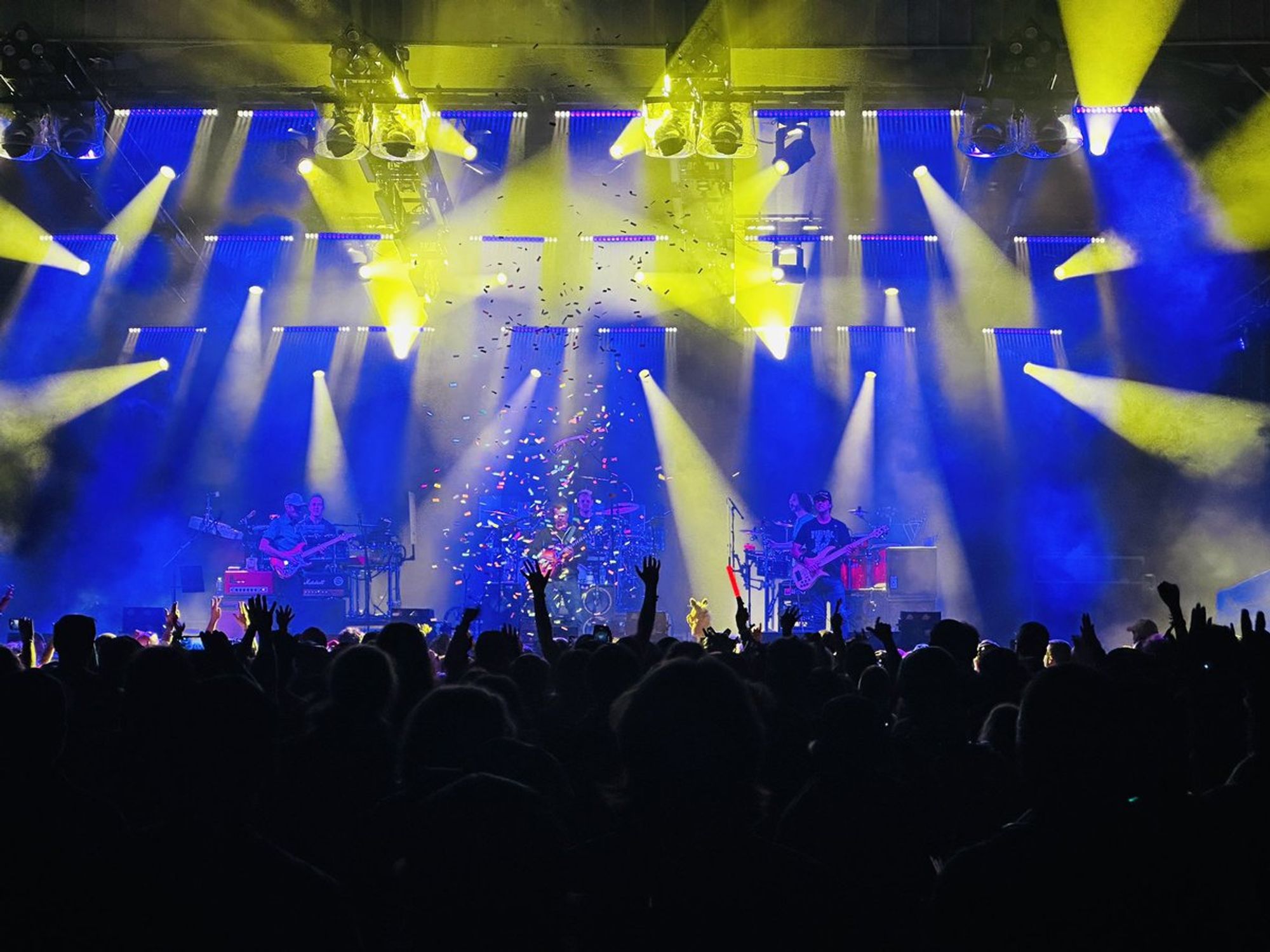 Stage awash in blue and yellow lighting.  A splash of confetti in the center.