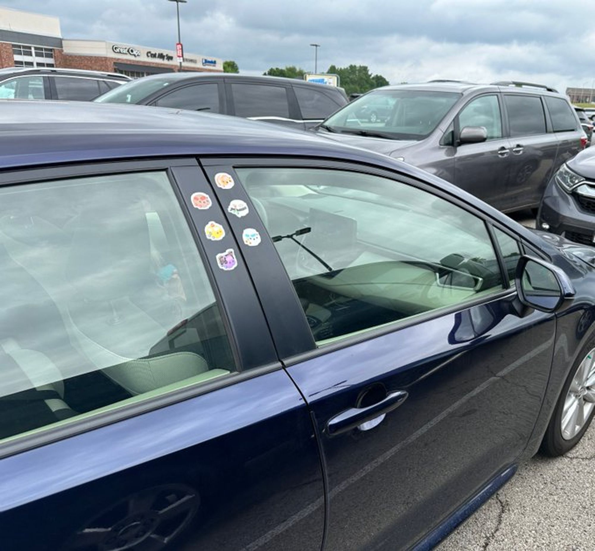 Blue car with six stickers on the door frame