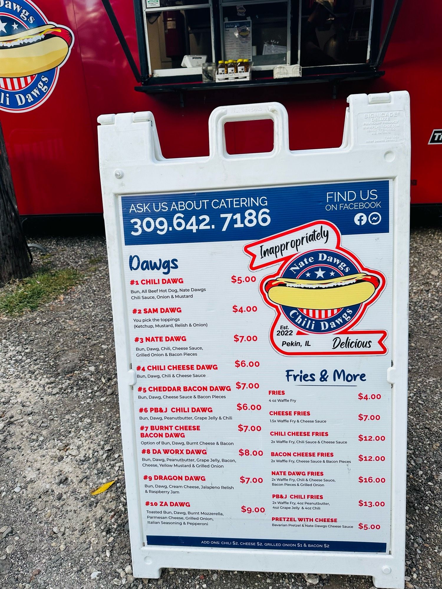 Nate Dawg’s Chili Dawgs menu placard in front of the food truck.