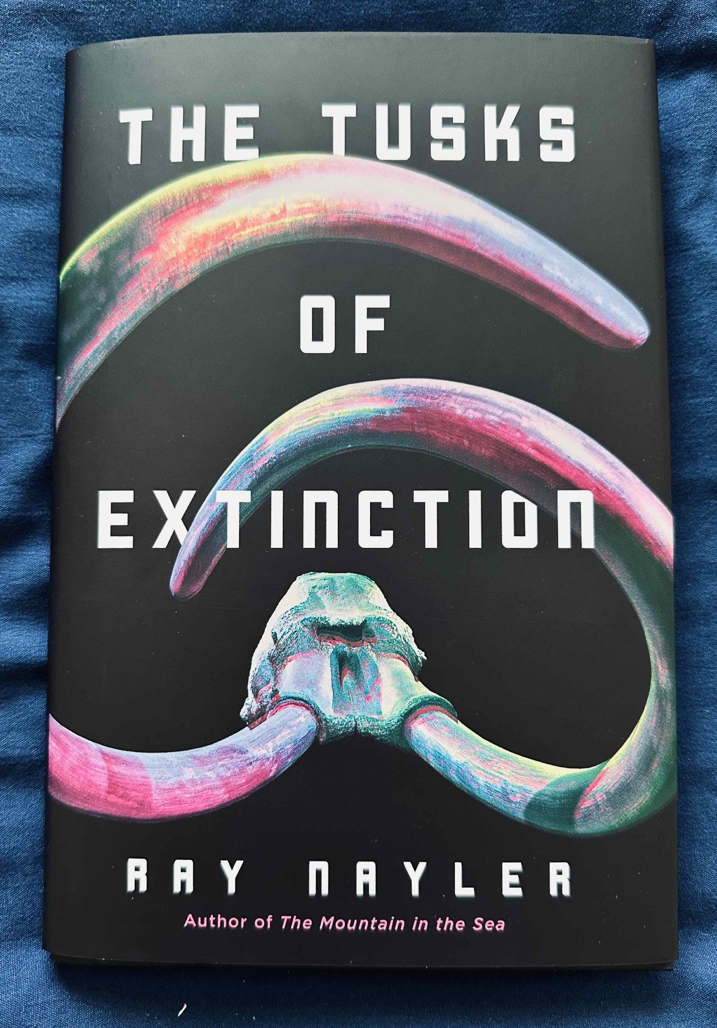 Book jacket illustration shows a mastodon skull with a pair of tusks.

Text:

THE TUSKS
OF
EXTINCTION

RAY NAYLER
Author of The Mountain in the Sea