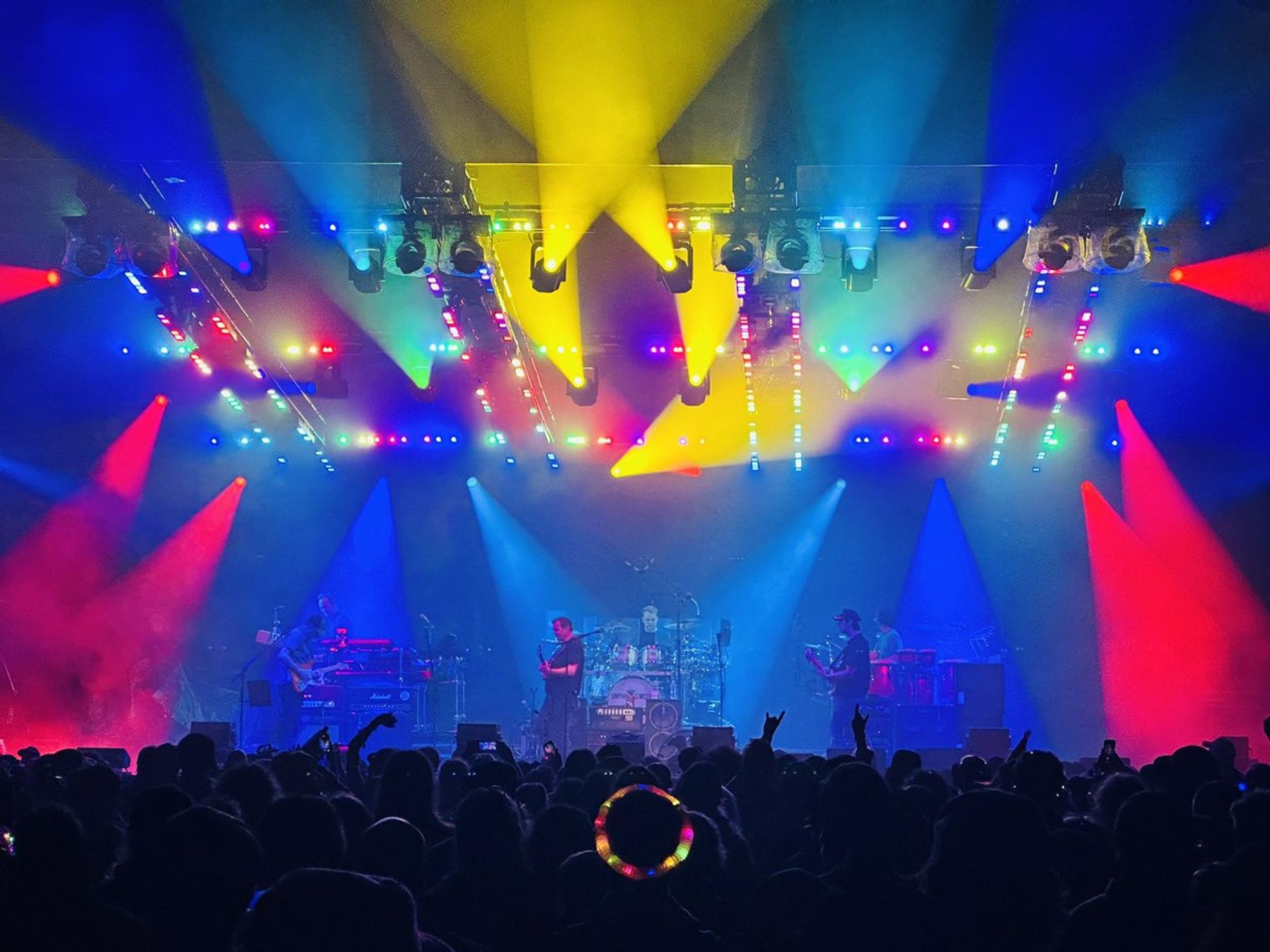 Skittle-colored lights above and around the stage as the band plays.