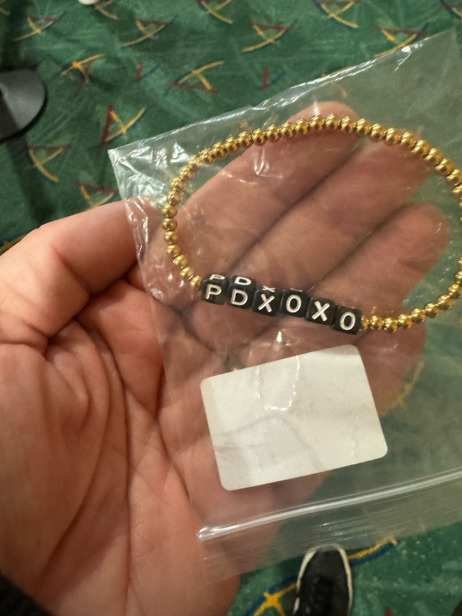 PDXOXO bracelet being held in the security line at PDX