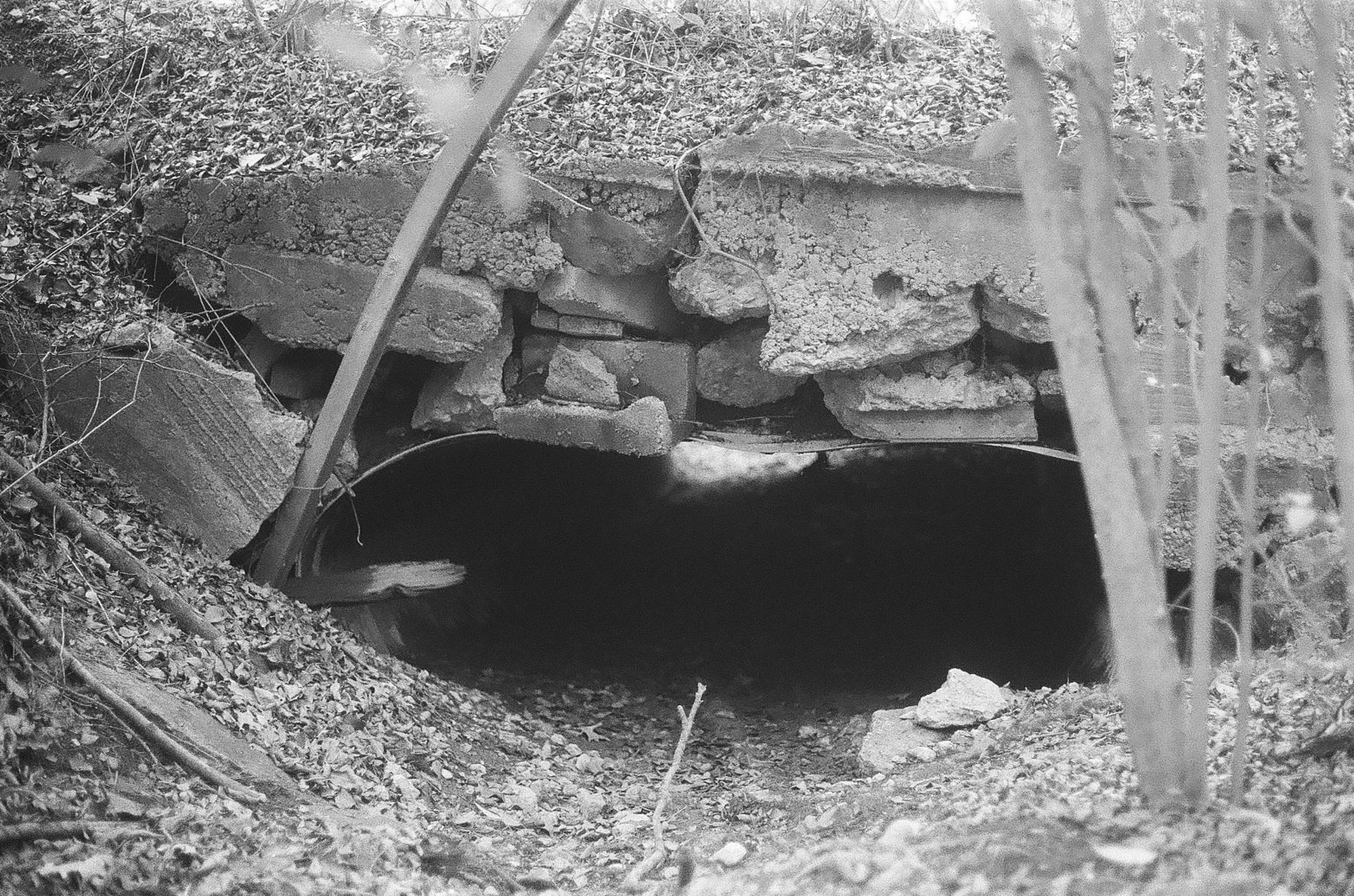 Stone bridge with dry drainage underneath in black and white